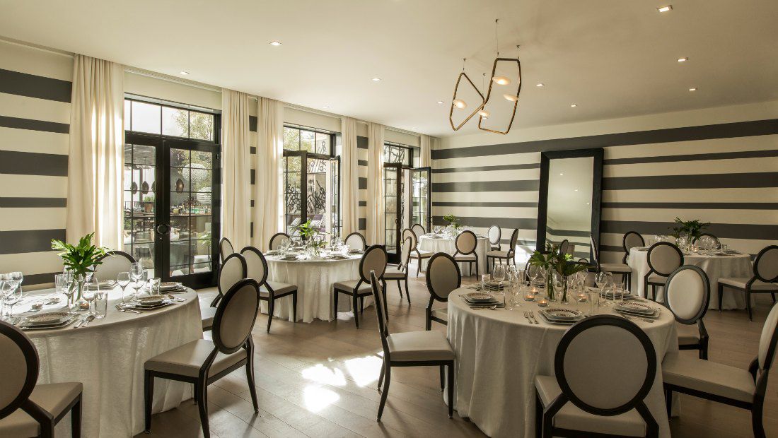 a beautiful dining room with contemporary decor and french doors providing plenty of natural lighting