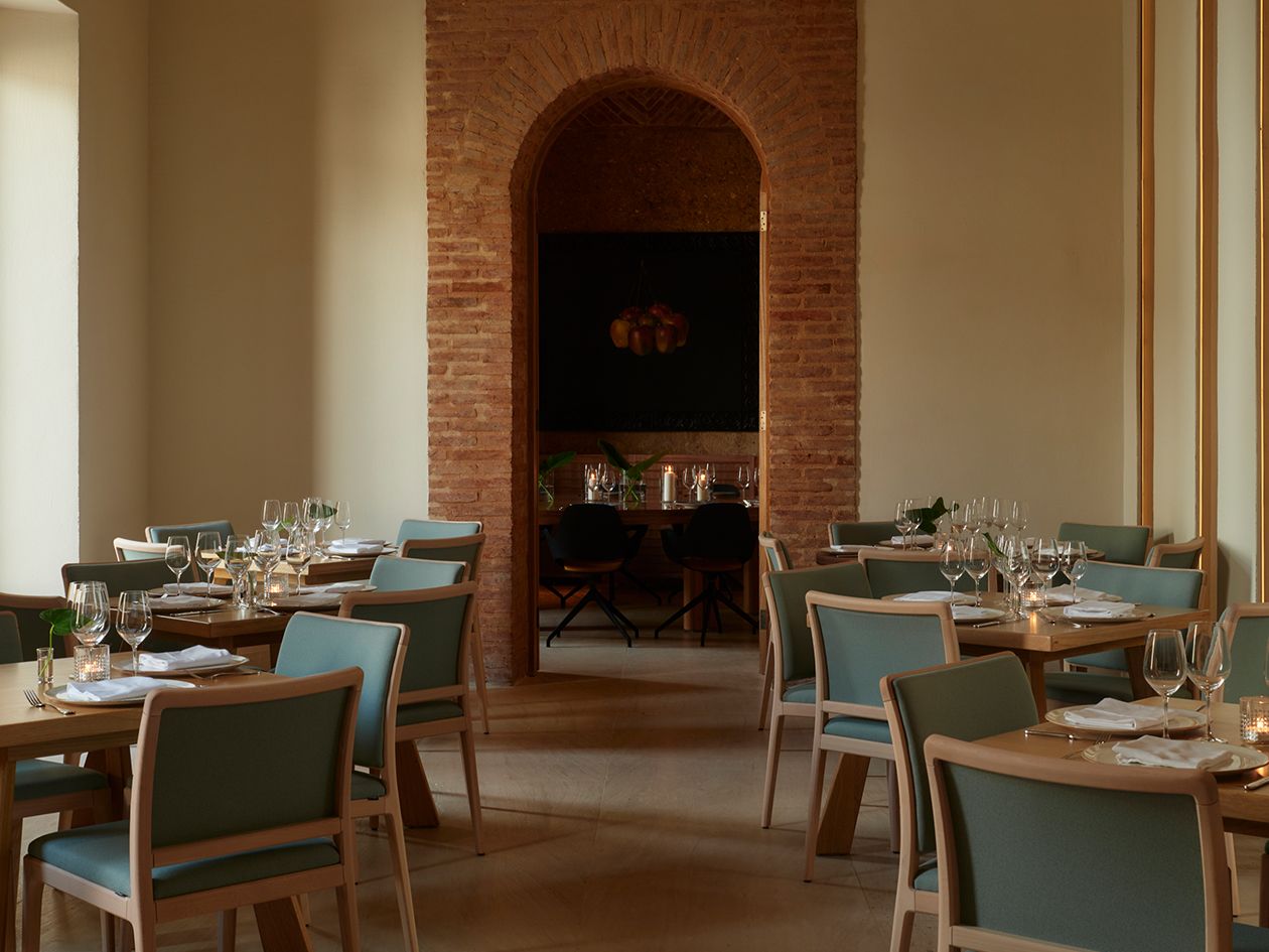 intimate dining room with brick arched doorway