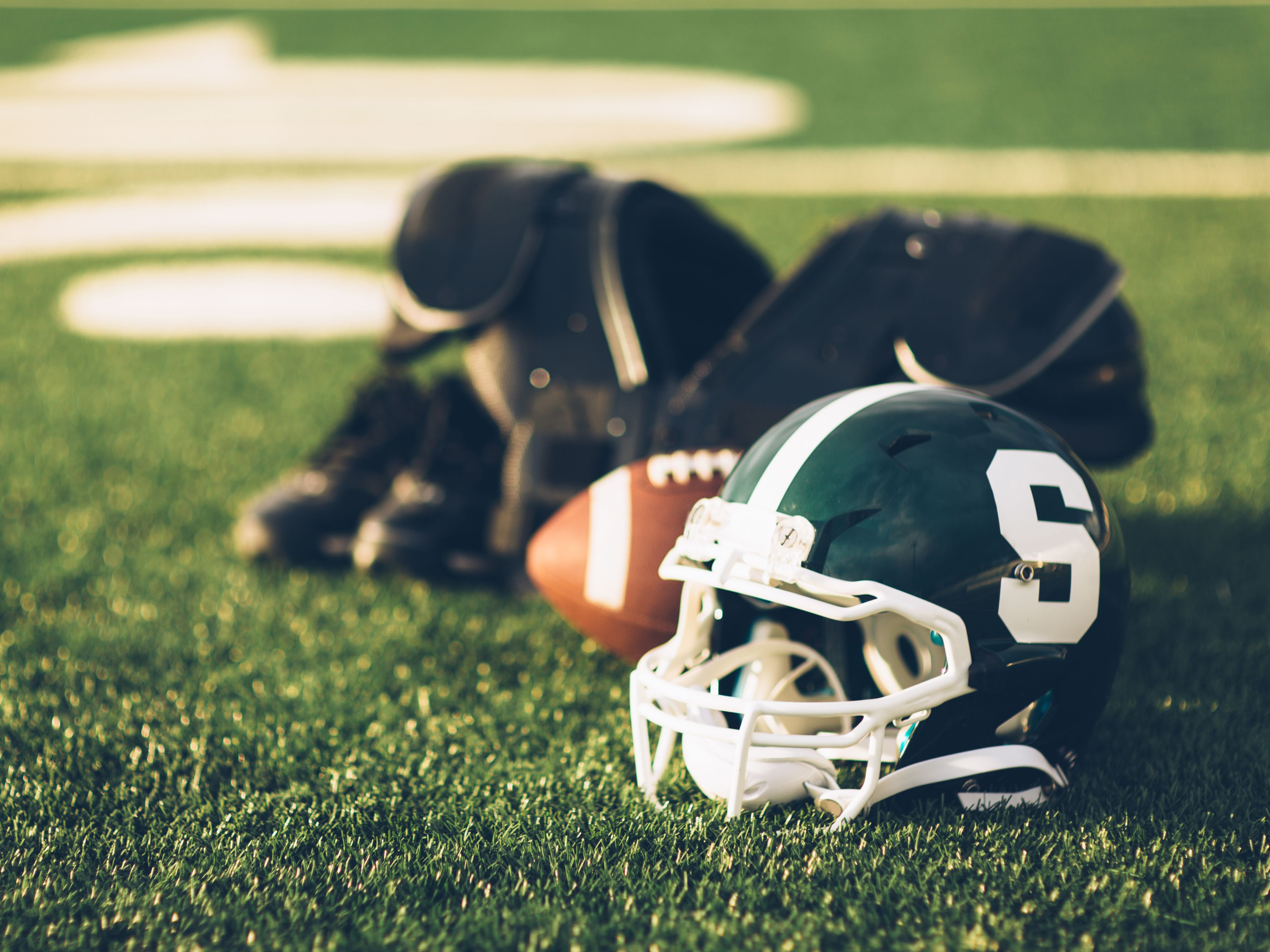 football helmet and football sitting on the field.
