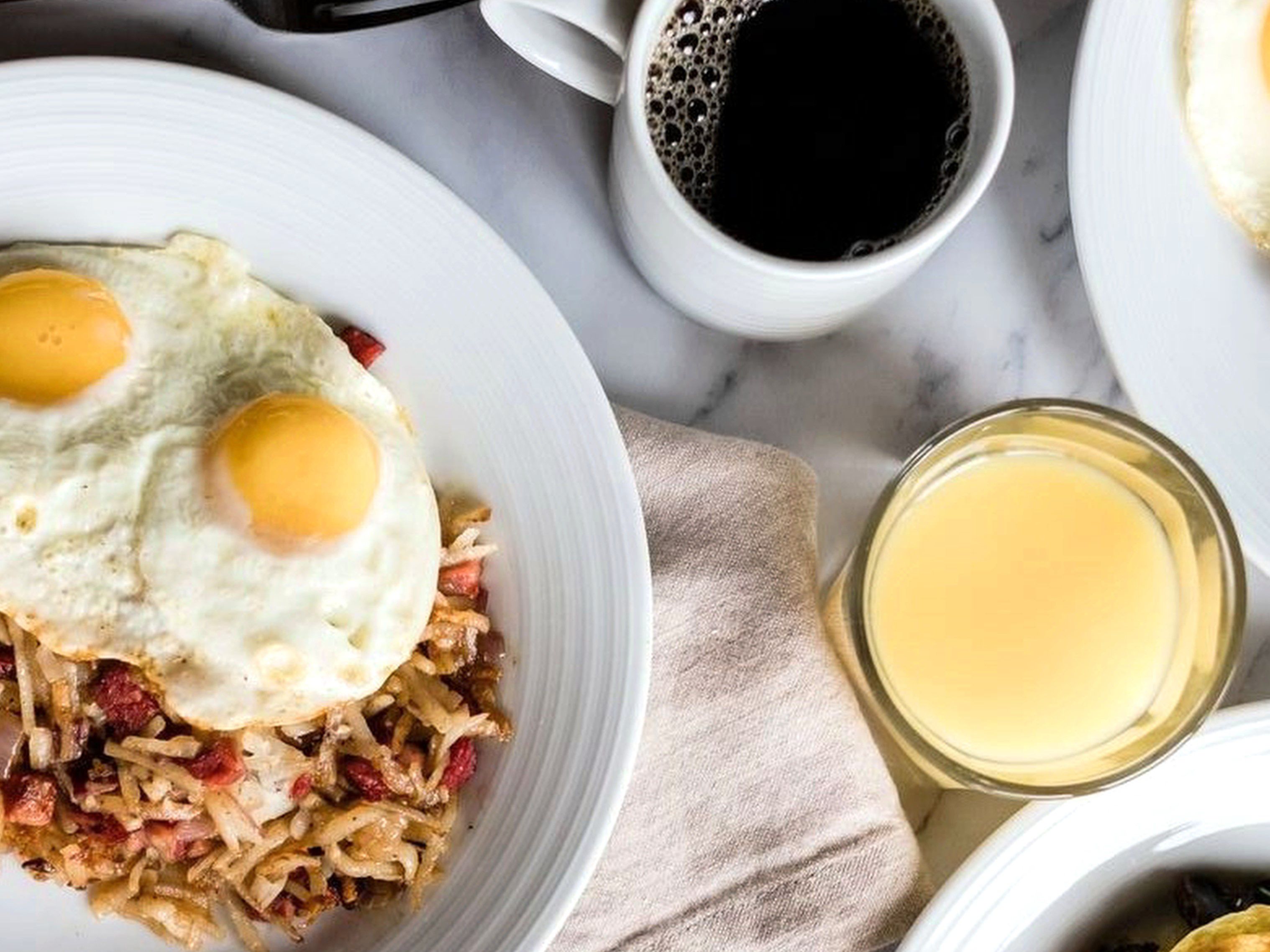 Breakfast with coffee, juice, and eggs over easy