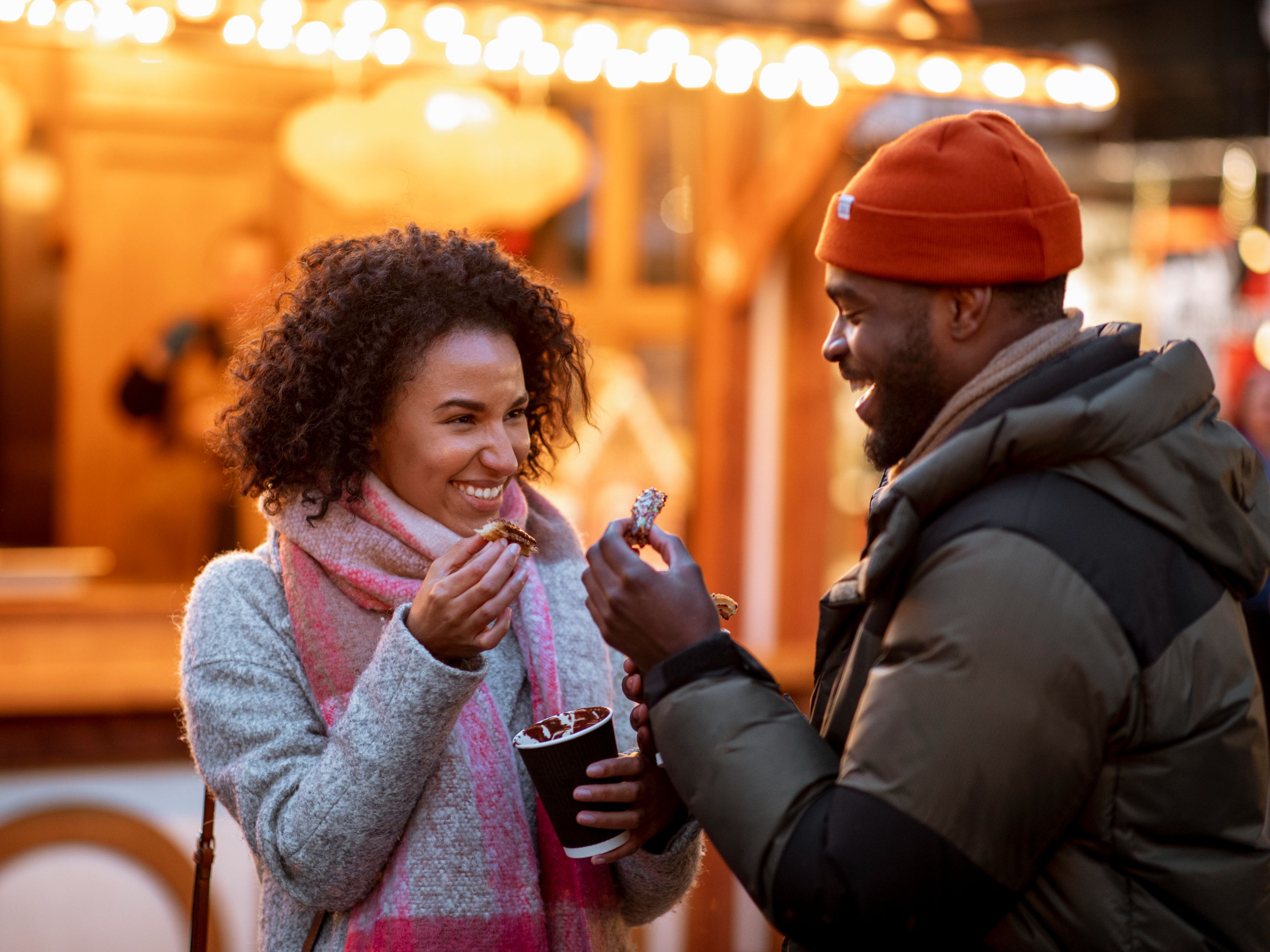 Couple drinking hot chocolate at festival