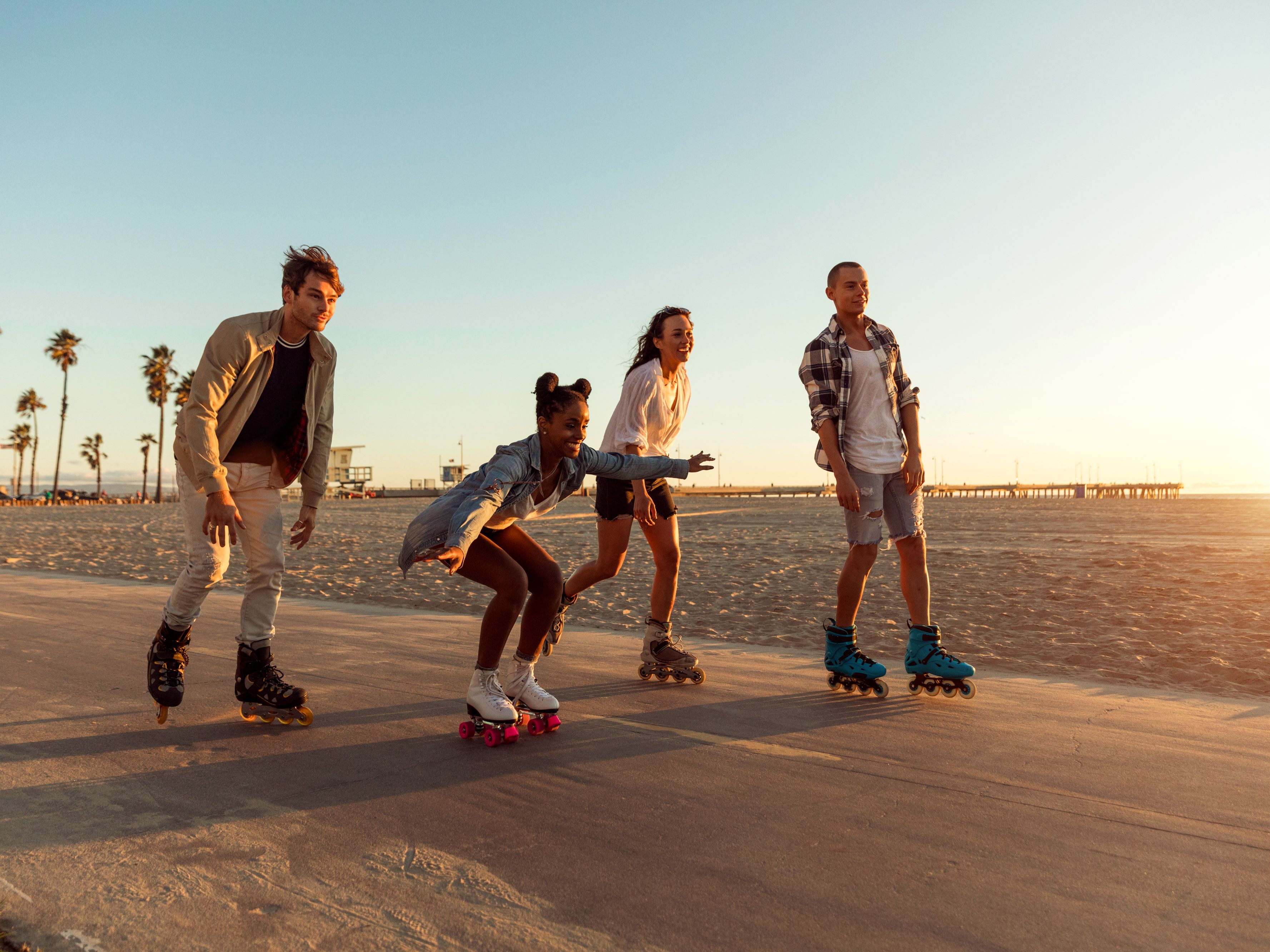 people skating in front of the board walk
