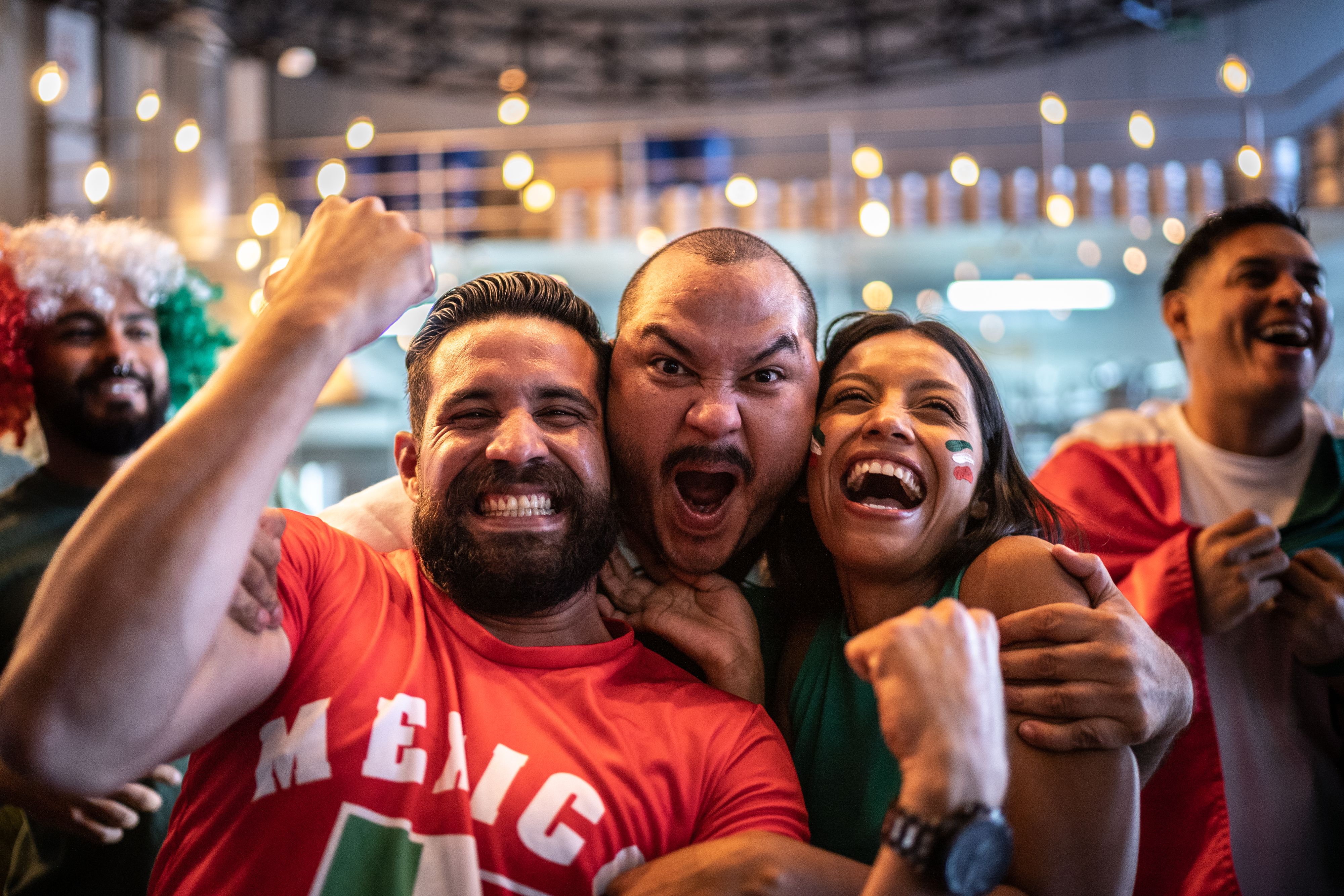Soccer fans cheering and supporting Mexico.