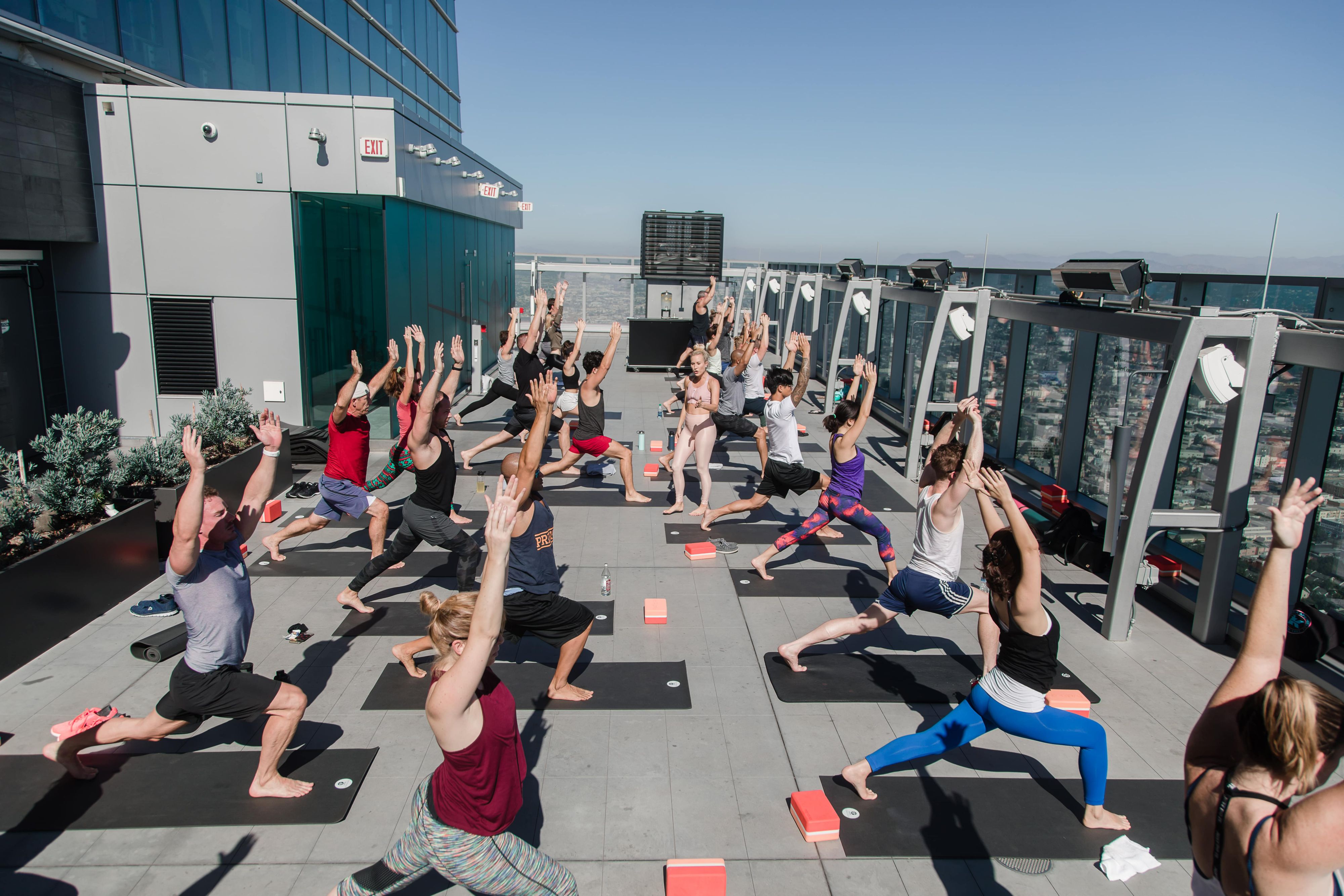 Group of people doing yoga on a rooftop at InterContinental Downtown Los Angeles
