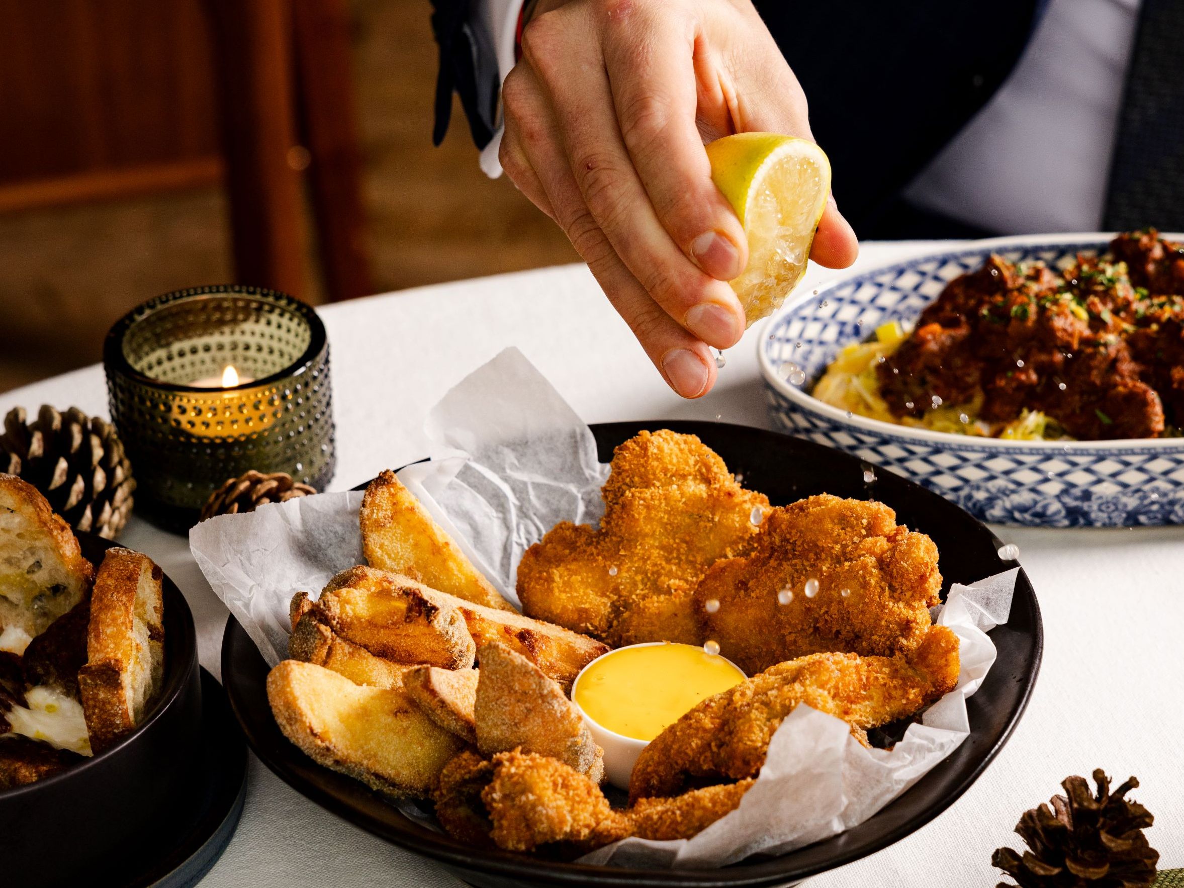 Squeezing lemon on fish 