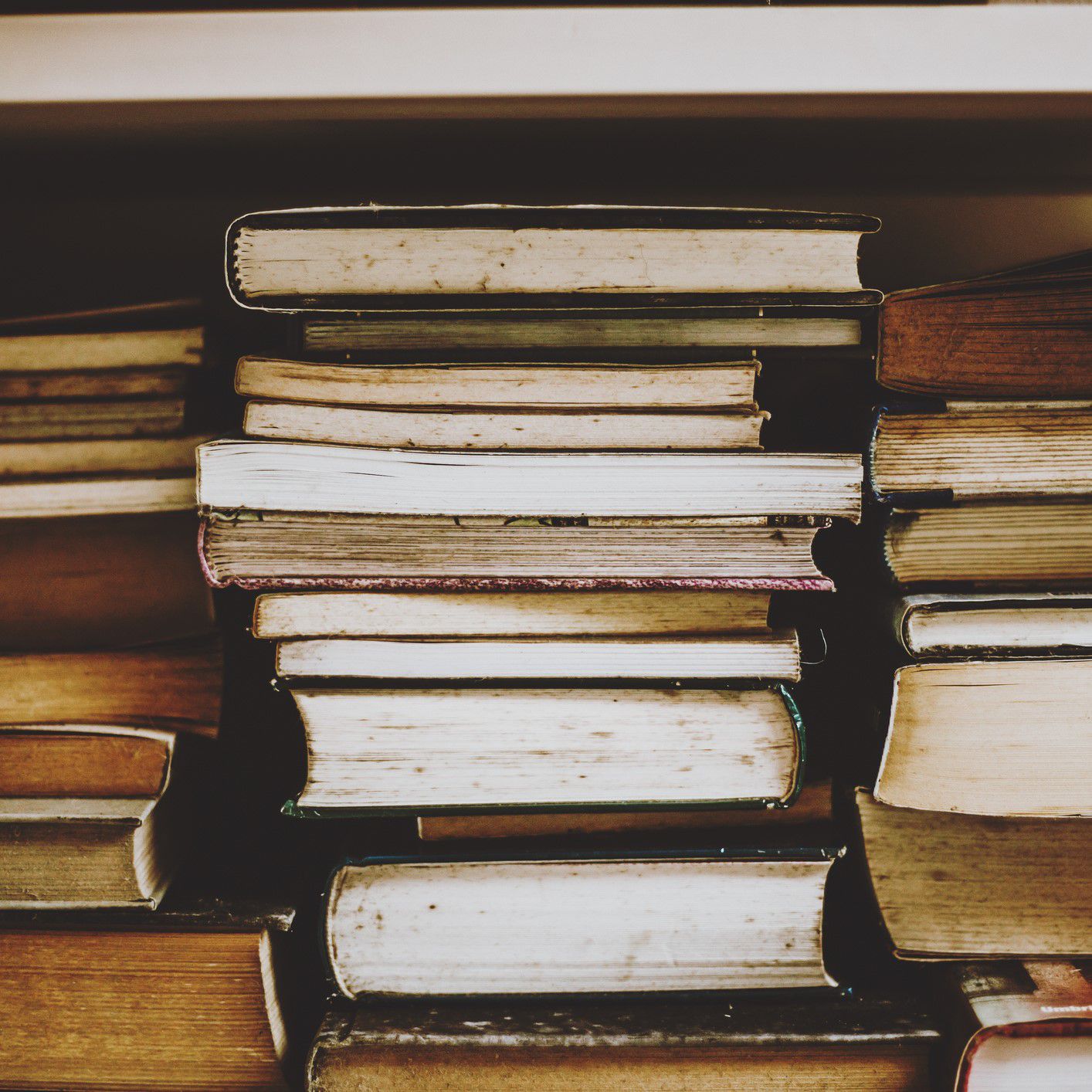 A stack of old books on a shelf