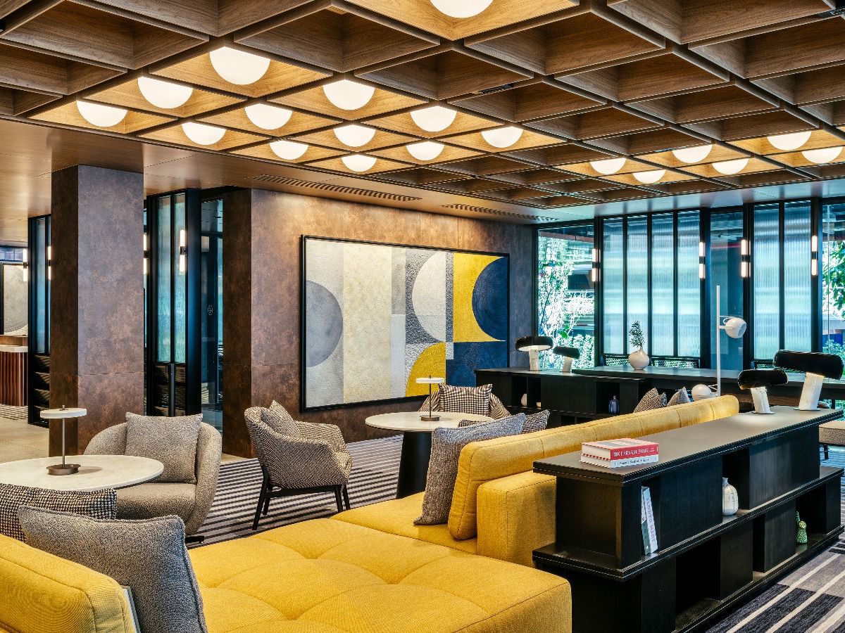 Modern hotel lounge featuring comfortable seating, warm lighting, and contemporary décor.