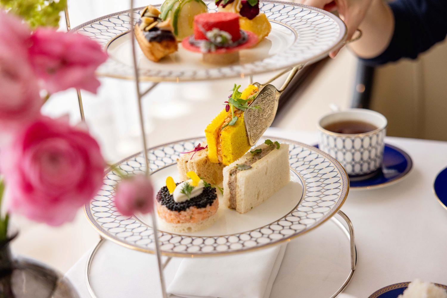 Wellington Lounge Afternoon Tea with pink flowers and snadwiches