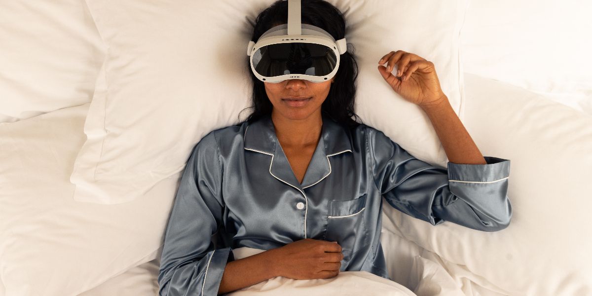 Woman laying in bed with a sleep mask on her face