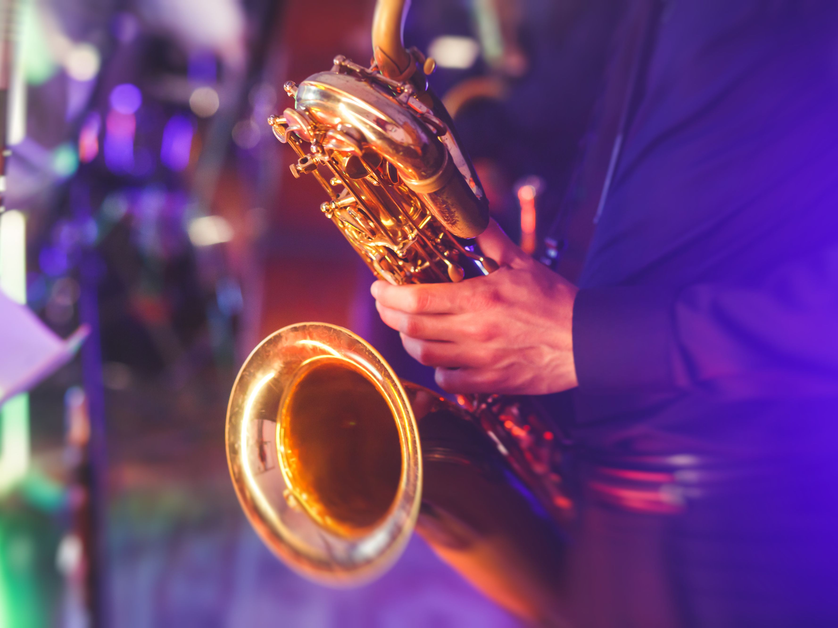 Close up of a man playing the saxaphone.