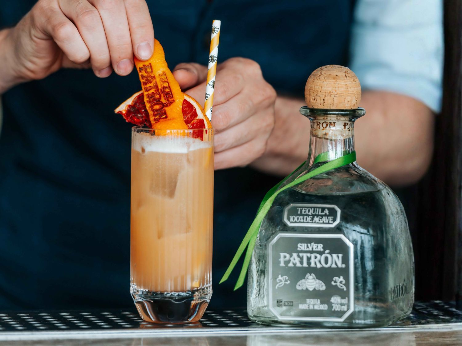 bartender making a paloma with silver patron tequila