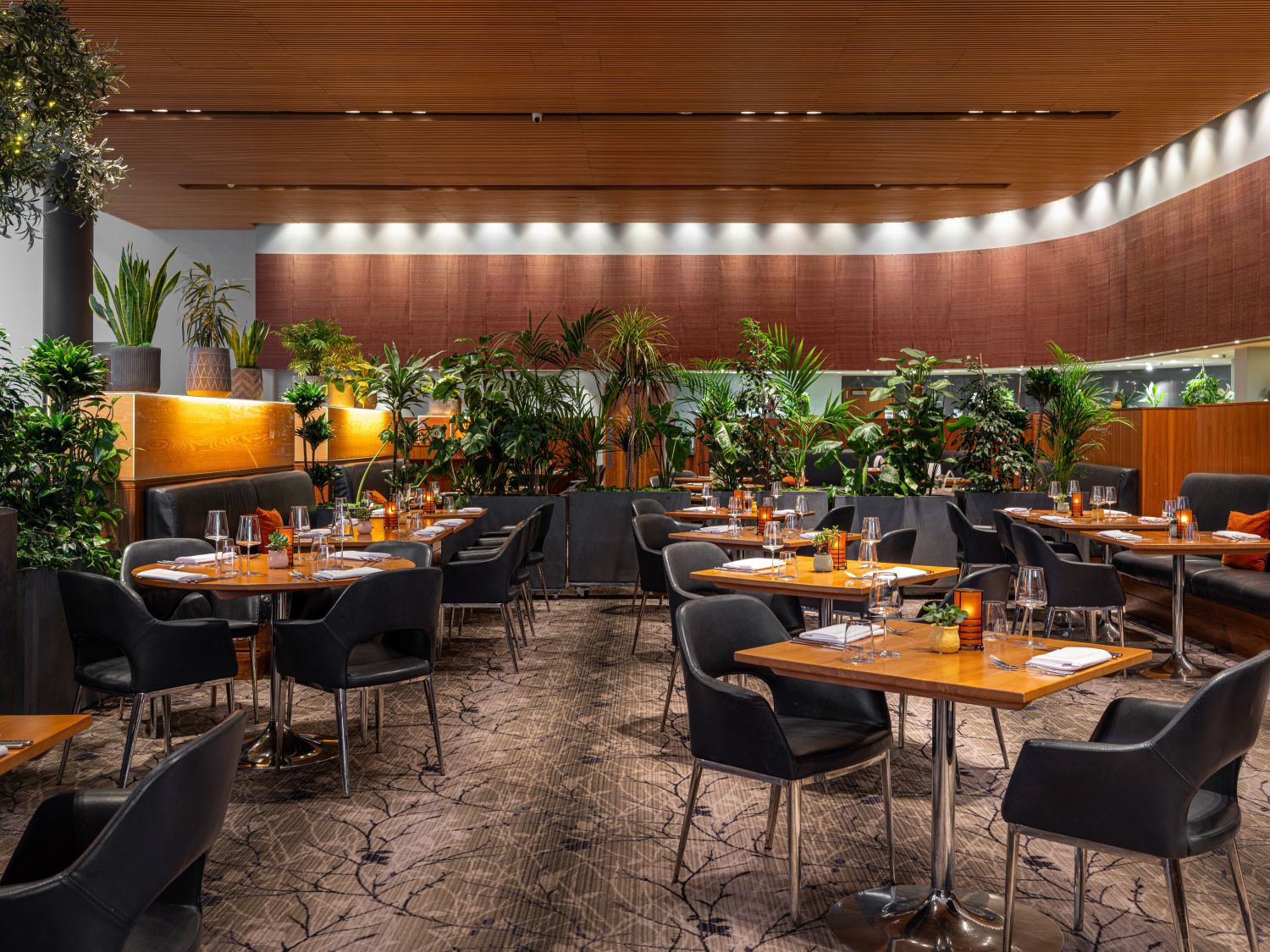 large seating area with plenty tables and plants