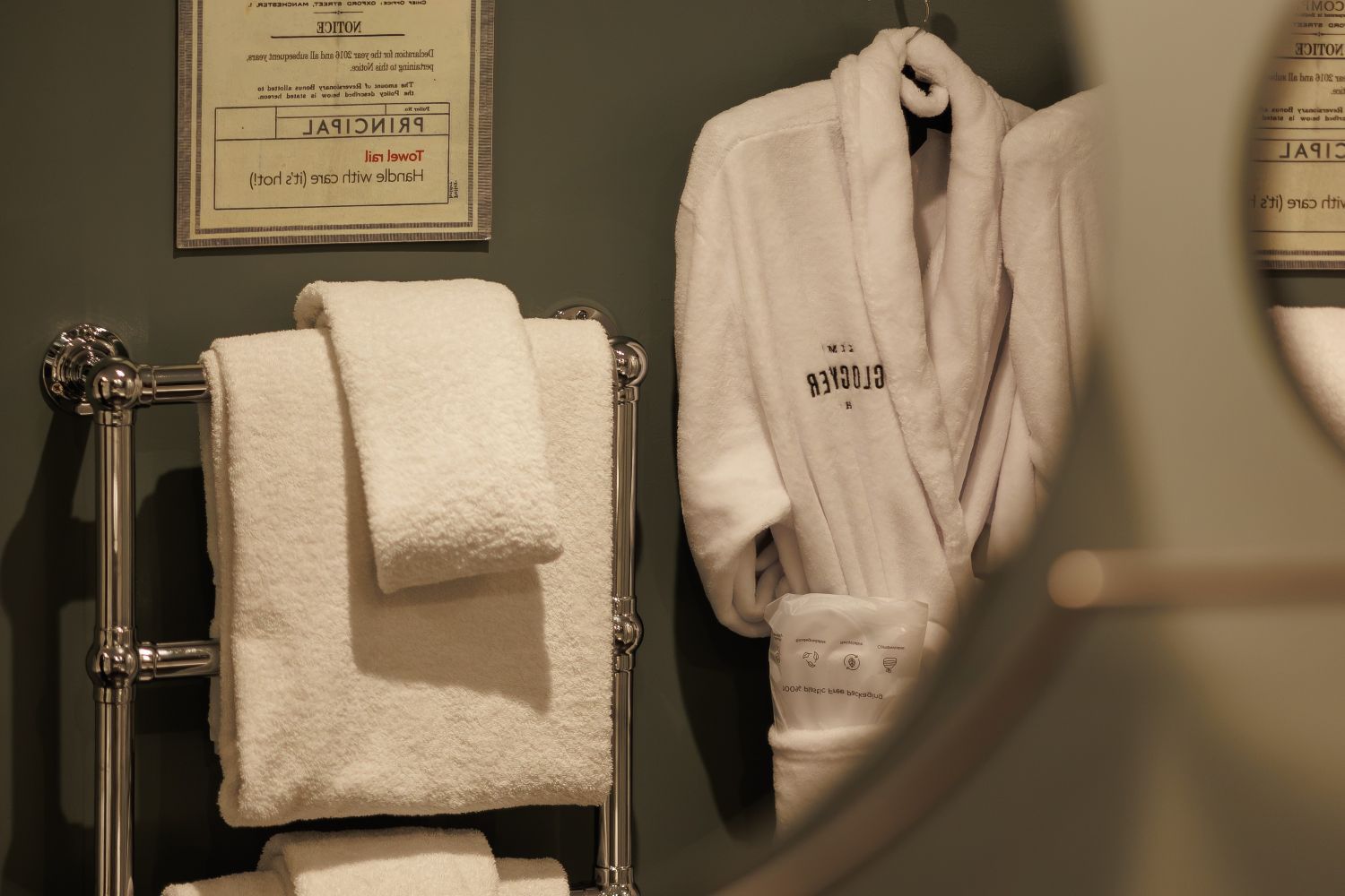 Kimpton Dressing Gown hanging in en suite with fresh white towels