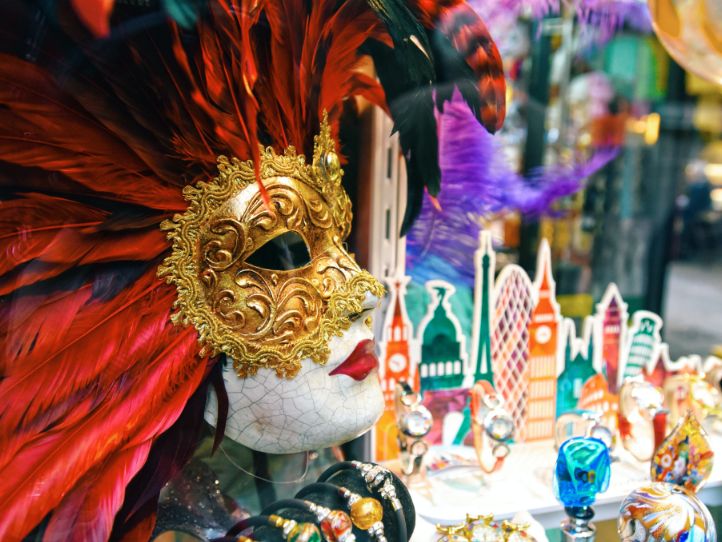 Mardi gras mask with small signage of buildings in background