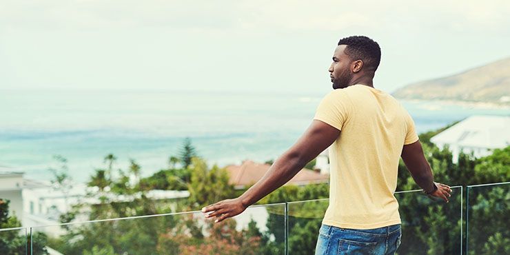 Man enjoying beach view from balcony