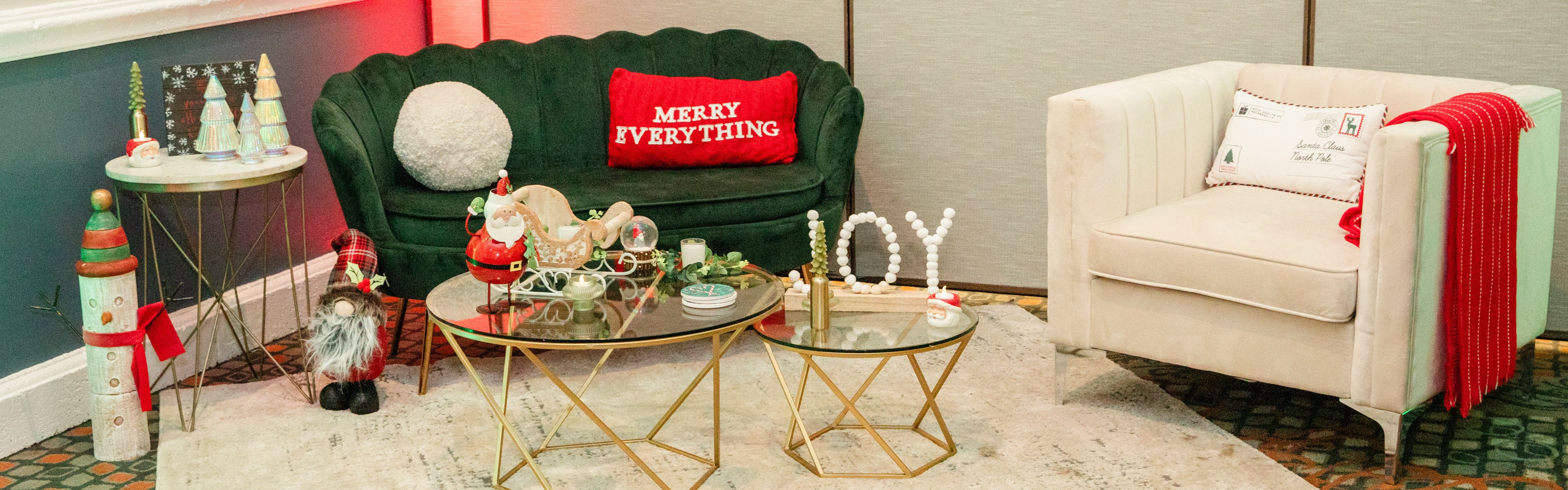 Holiday lounge with green velvet sofa and Merry Everything pillow.