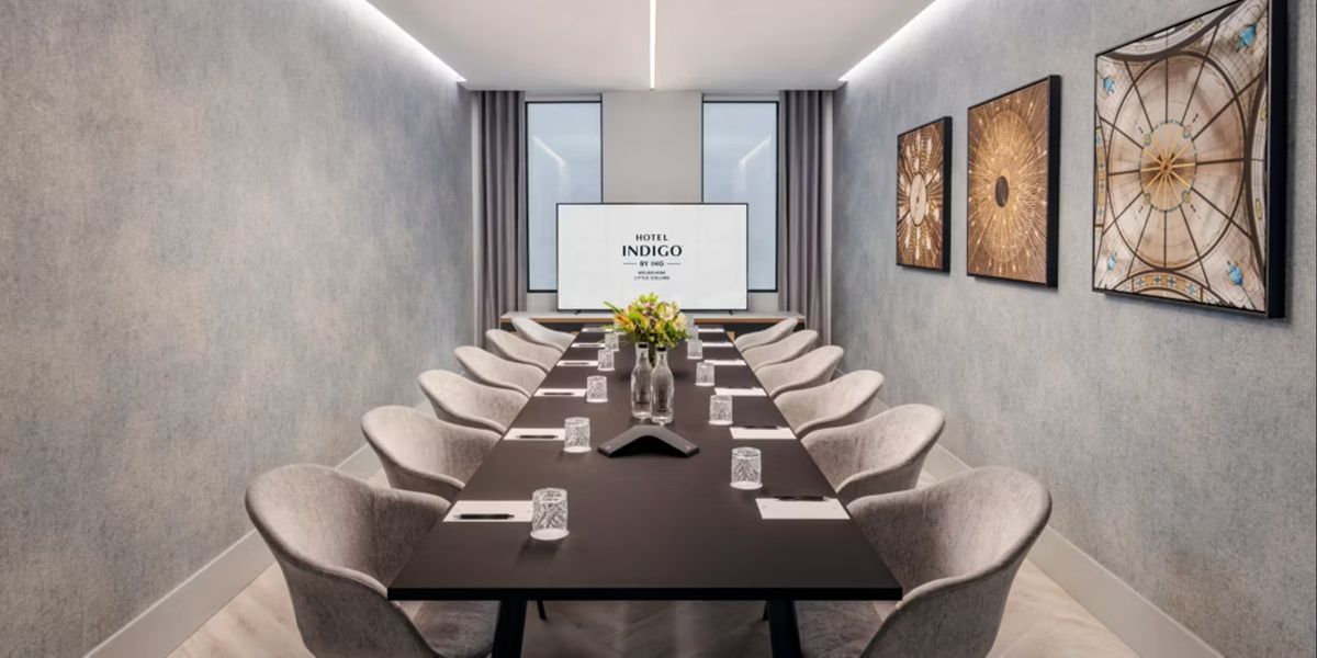 Modern meeting room with conference table and chairs.