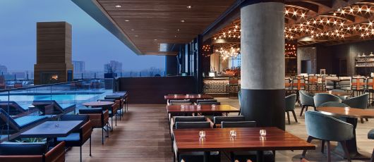 restaurant opens up to pool deck at dusk