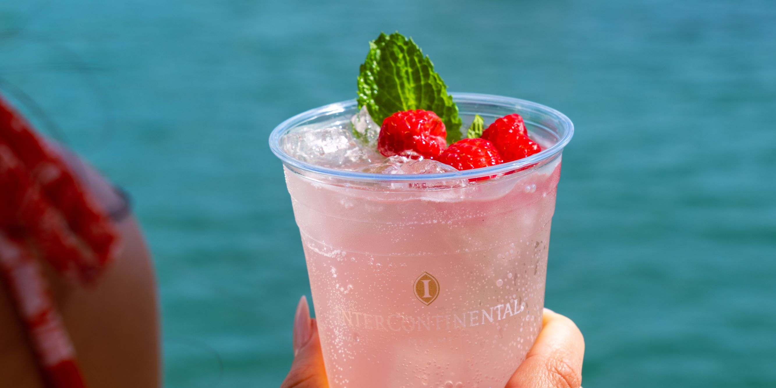 Woman holding berry cocktail.