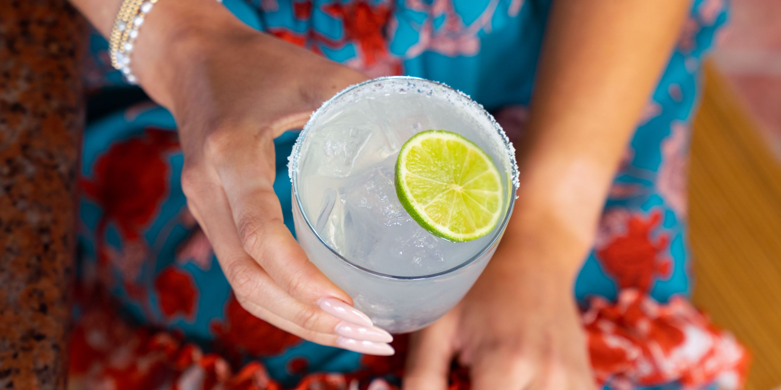 Woman holding a Bluewater cocktail.