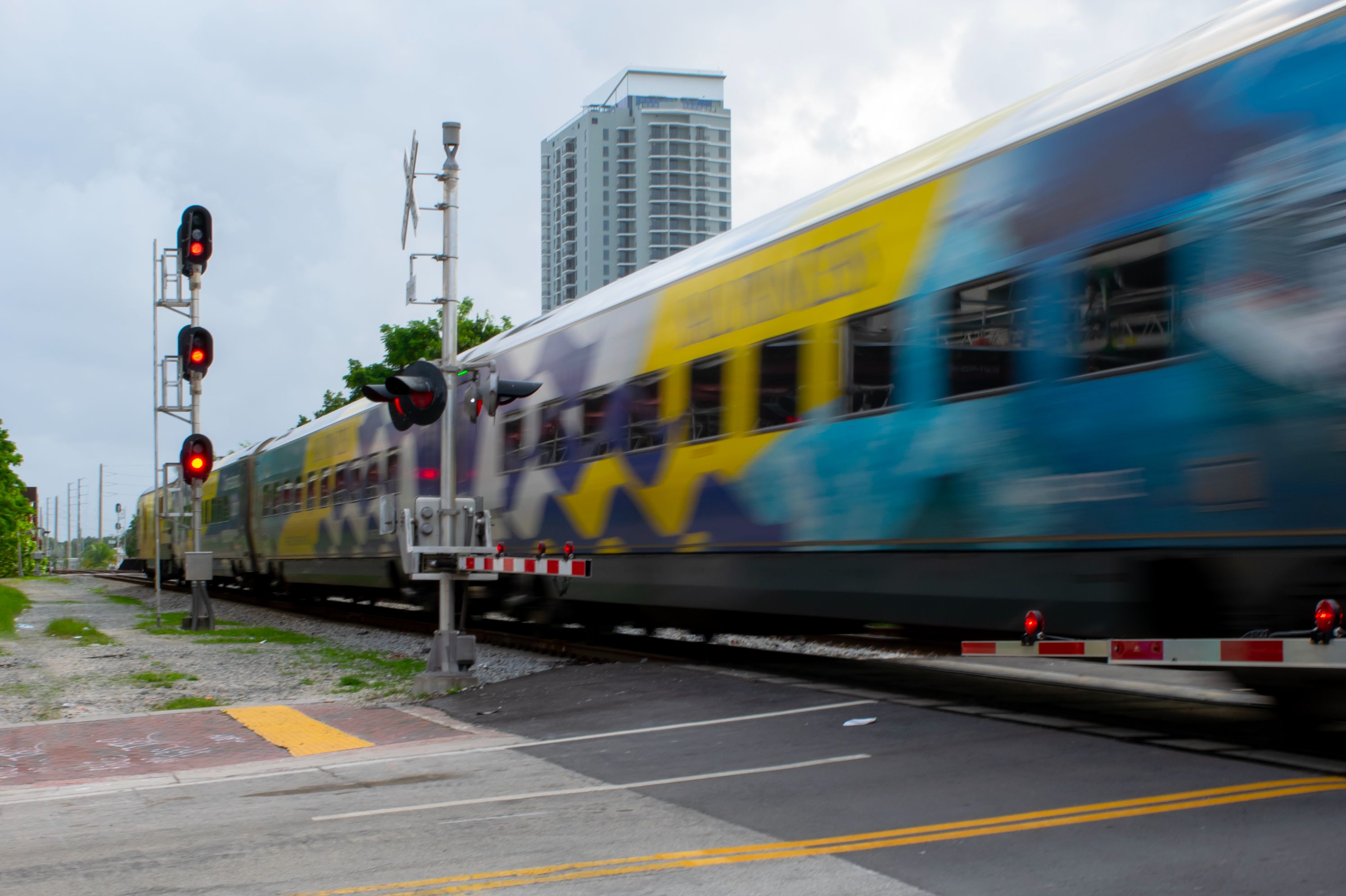 Brightline train speeding past on the track.