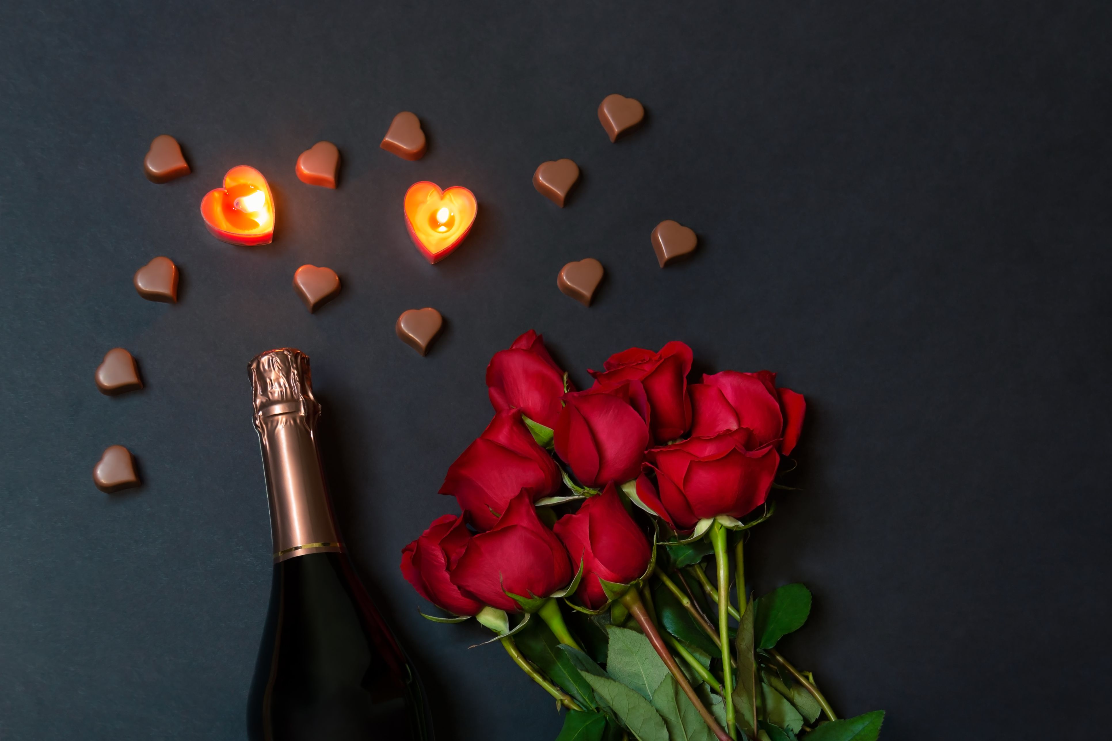 Wine, roses, and valentine's chocolate hearts.