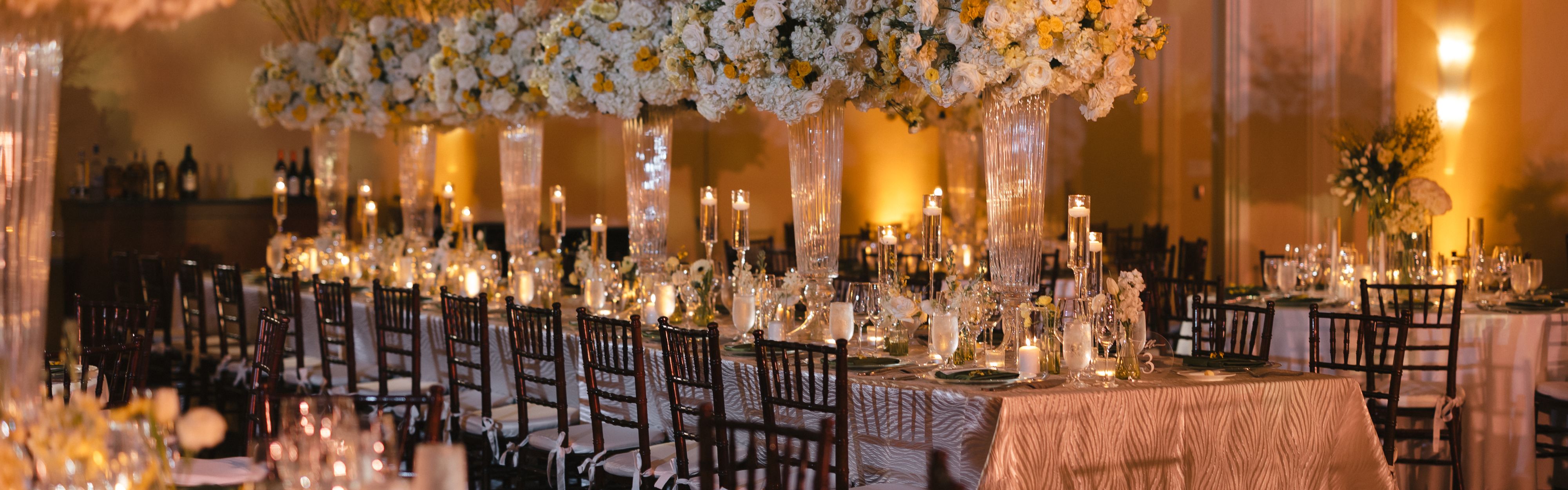 Table set up with decor and flowers at wedding reception.