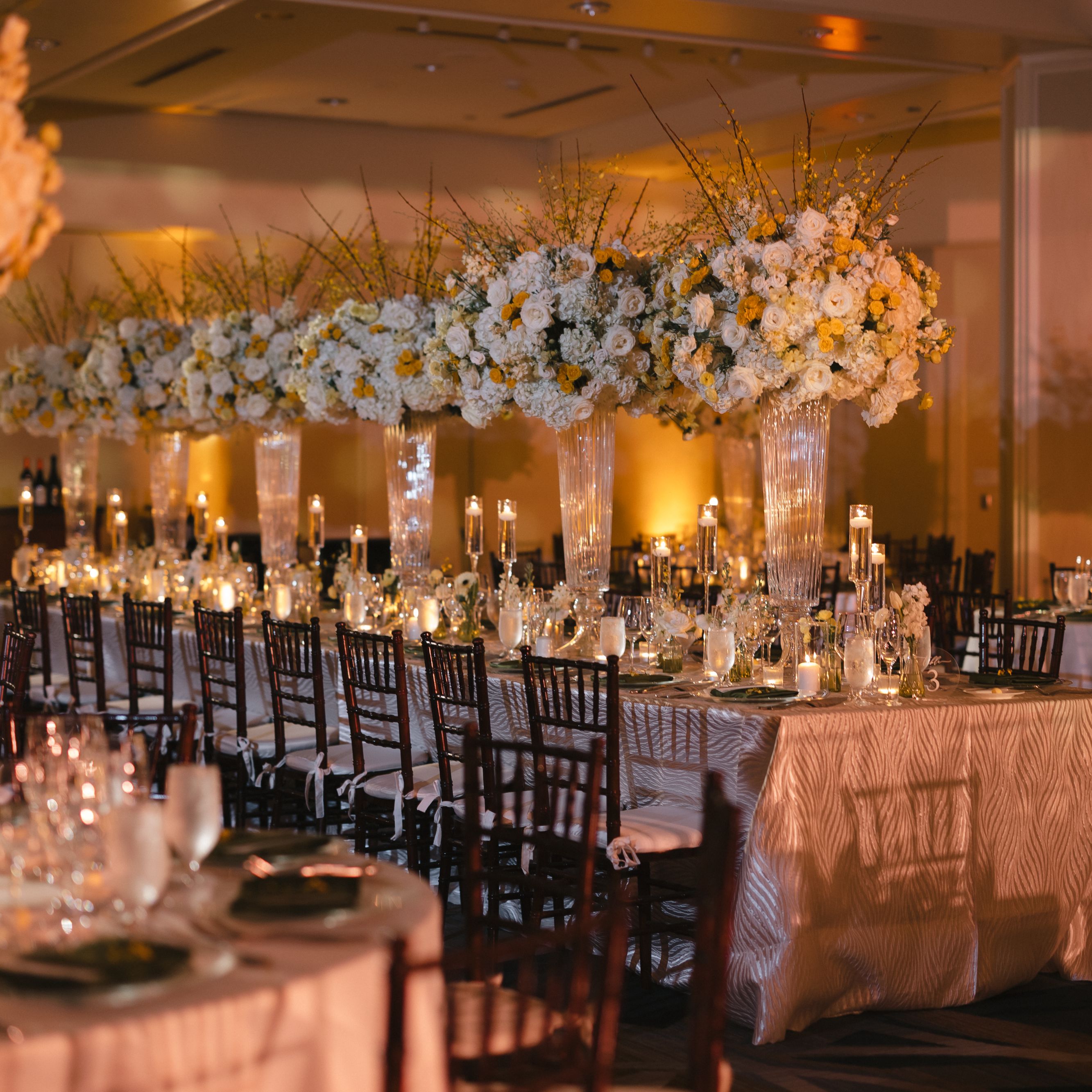 Table set up with decor and flowers at wedding reception.