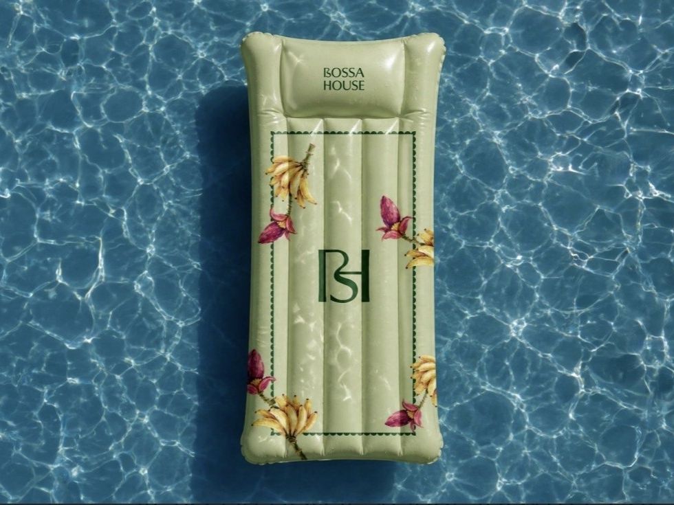 Decorative Bossa House pool float surrounded by sparkling blue water.