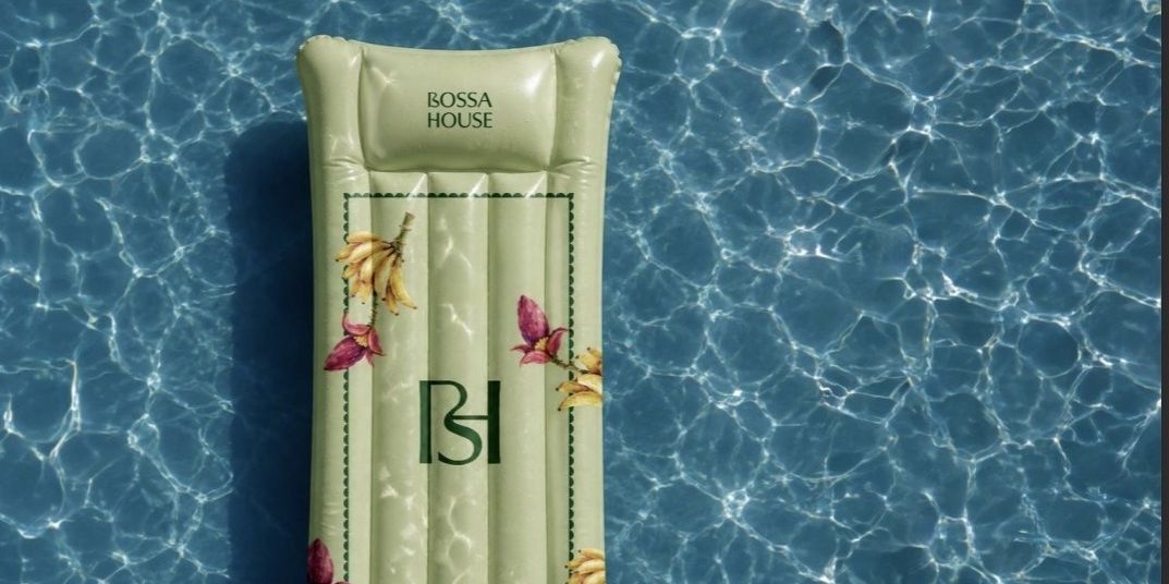 Decorative Bossa House pool float surrounded by sparkling blue water.