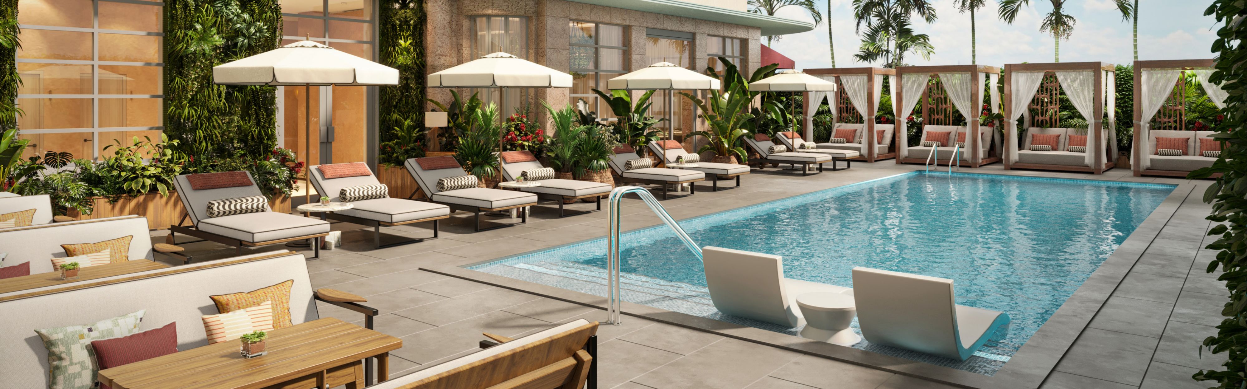 Pool terrace with cabanas and lounge chairs surrounded by tropical greenery.