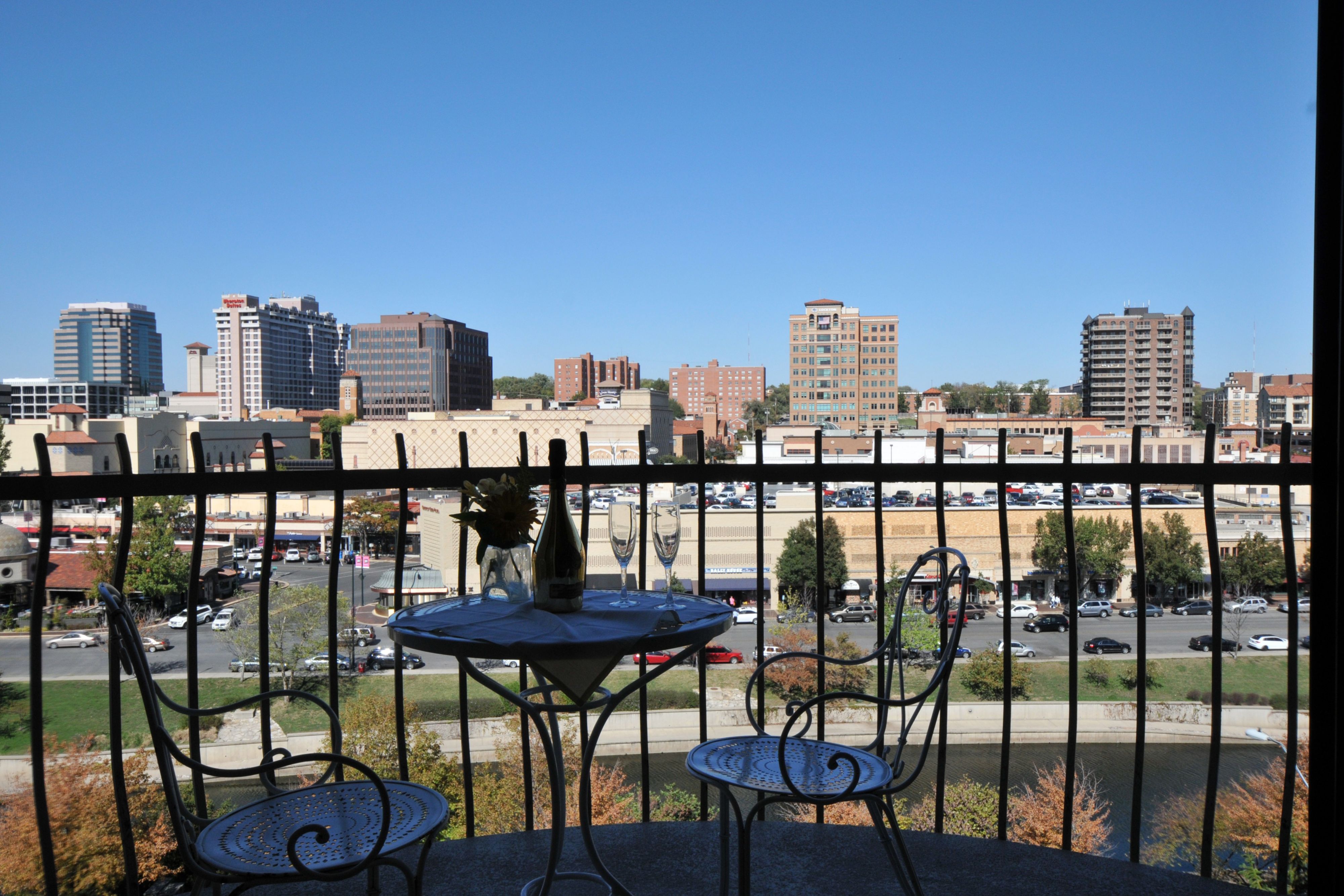 Balcony seating overlooking a downtown skyline on a clear day