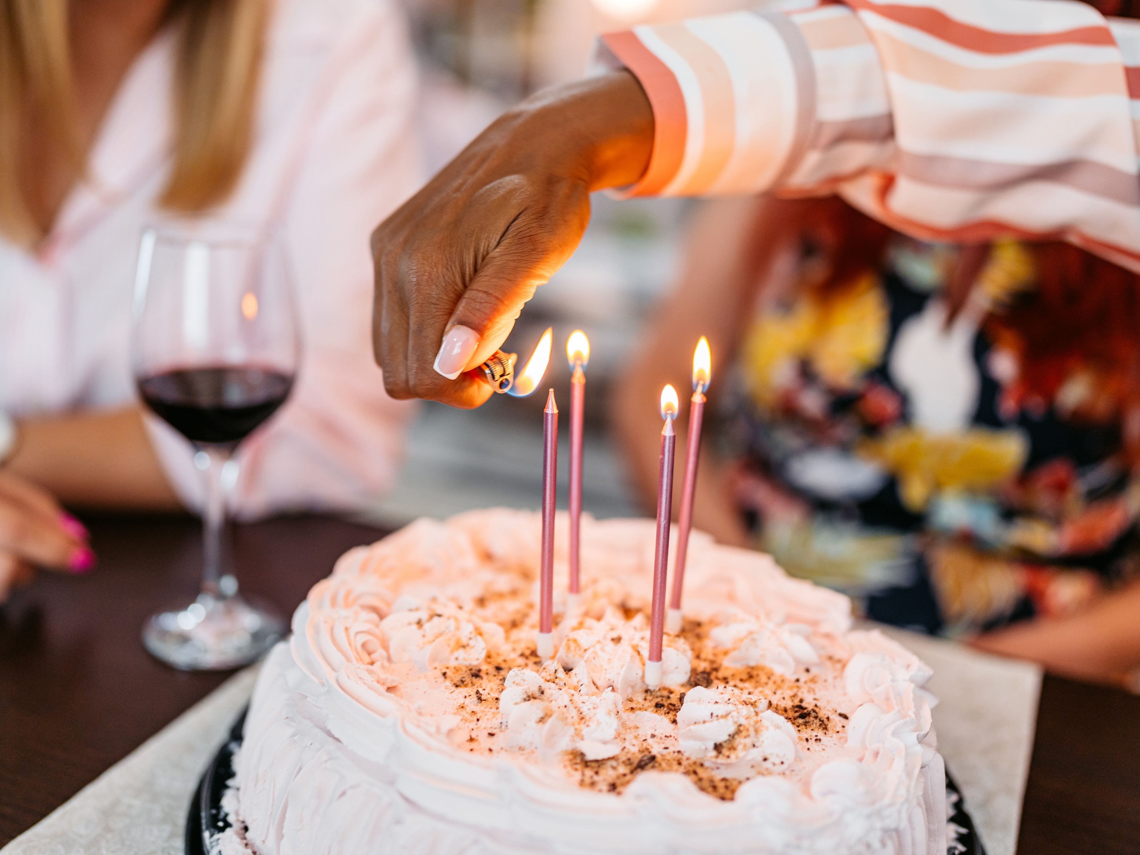 Birthday cake with lit candles at a restaurant celebration