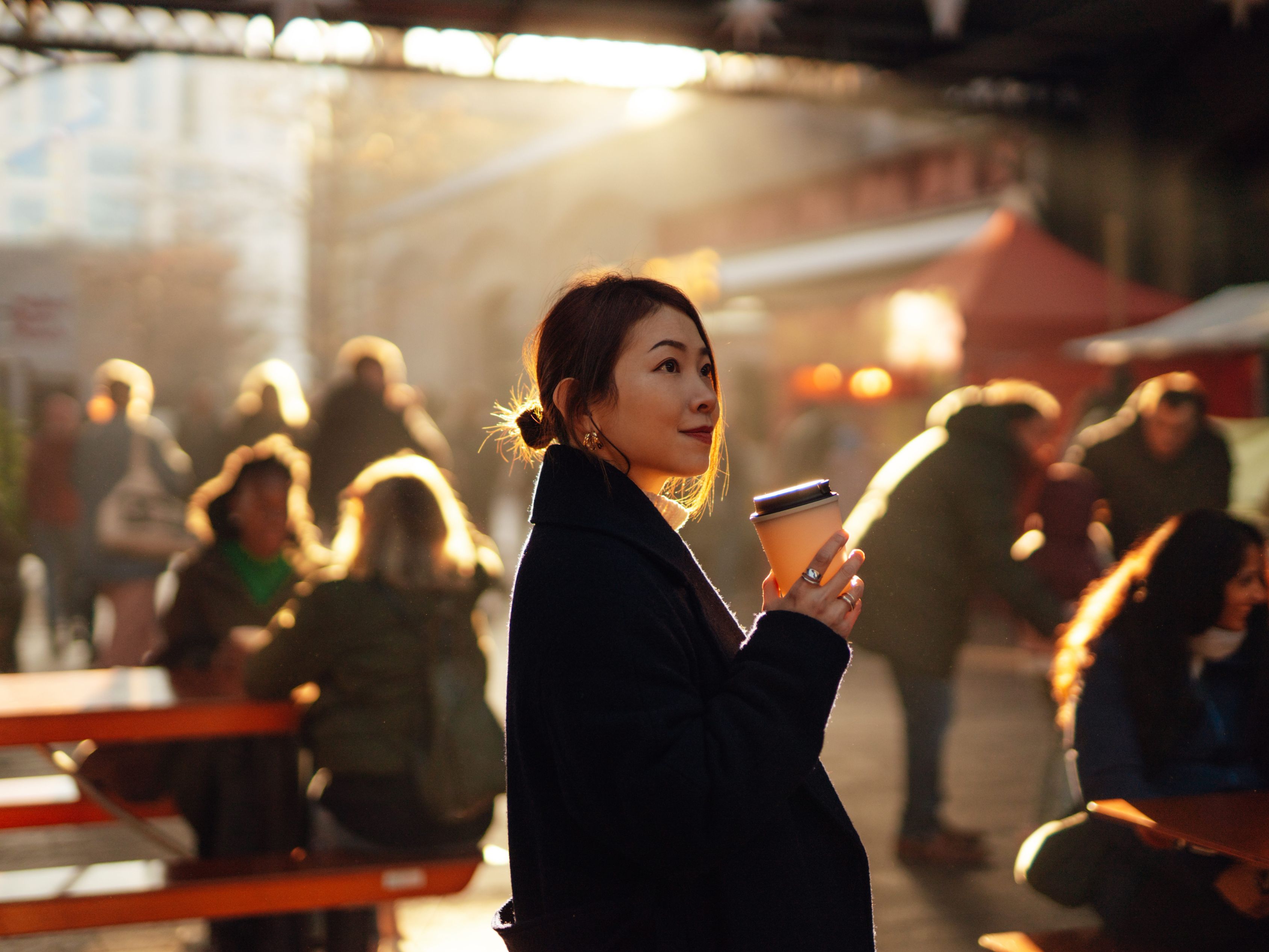Woman with a coffee at a public market