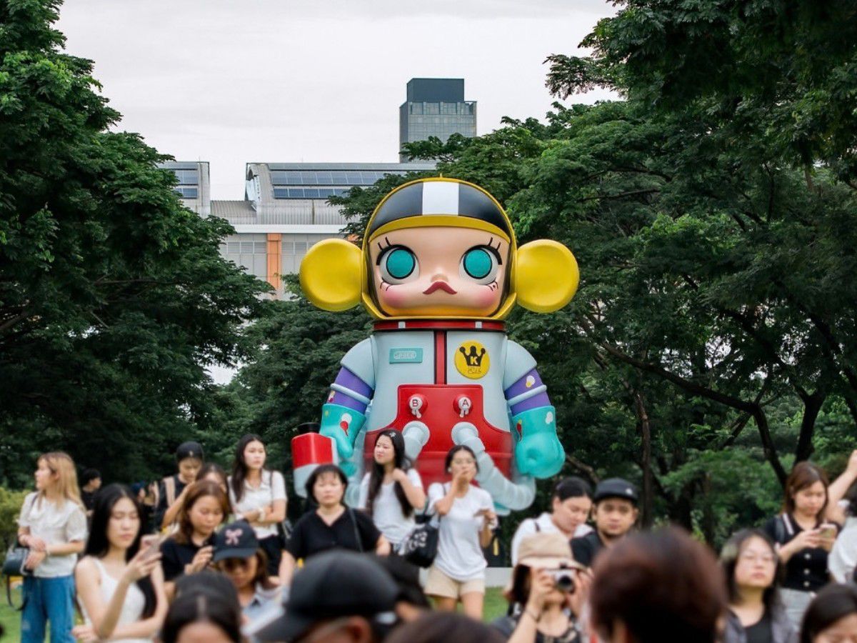 Giant Molly character statue surrounded by visitors in park