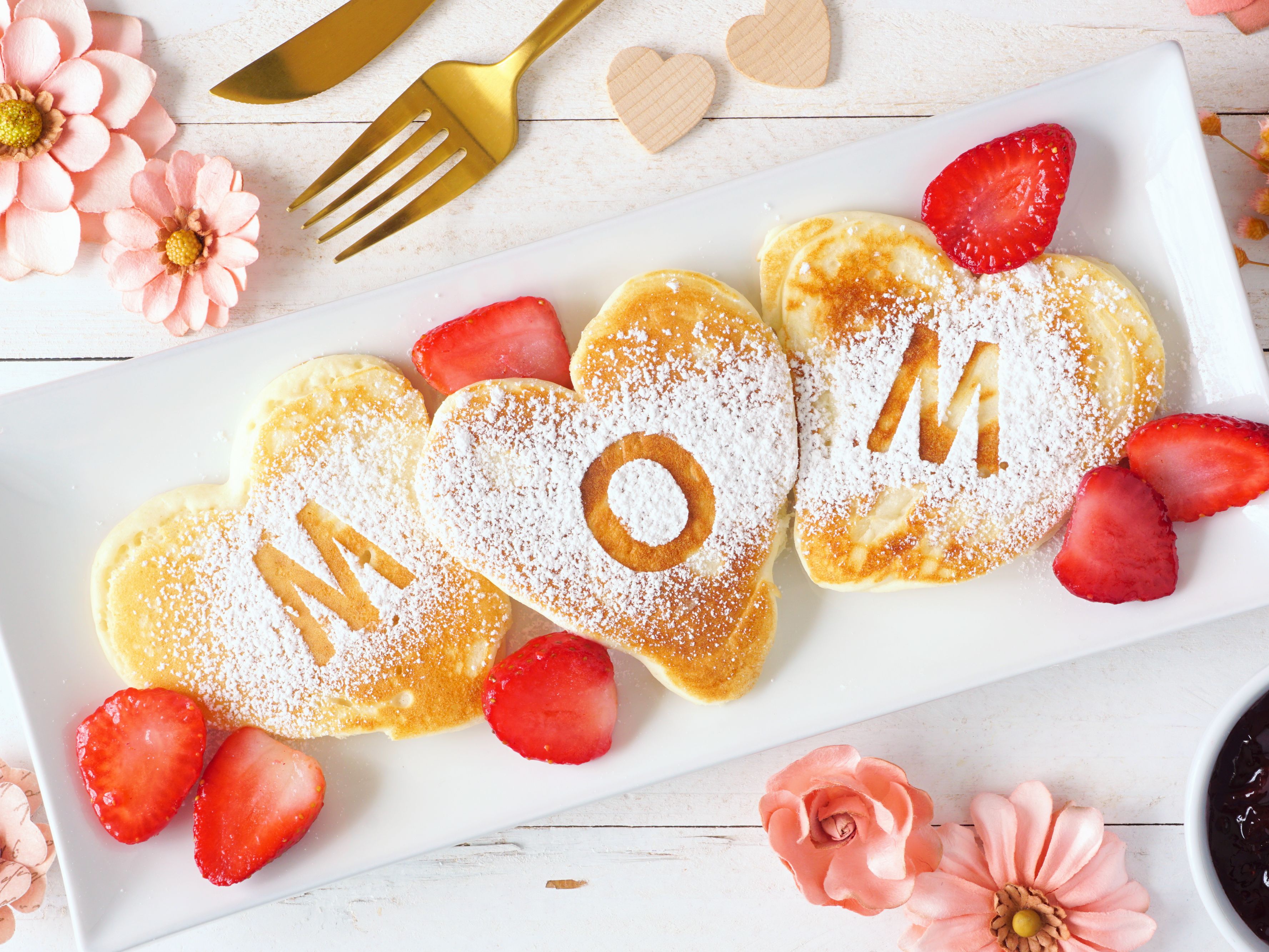 Mother's Day themed pancakes with MOM spelled out in powdered sugar.
