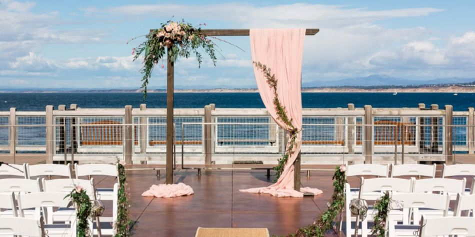 Wedding Arch with florals set up for a ceremony with an ocean view.