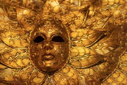 Gold Venetian-style mask with ornate decorative details