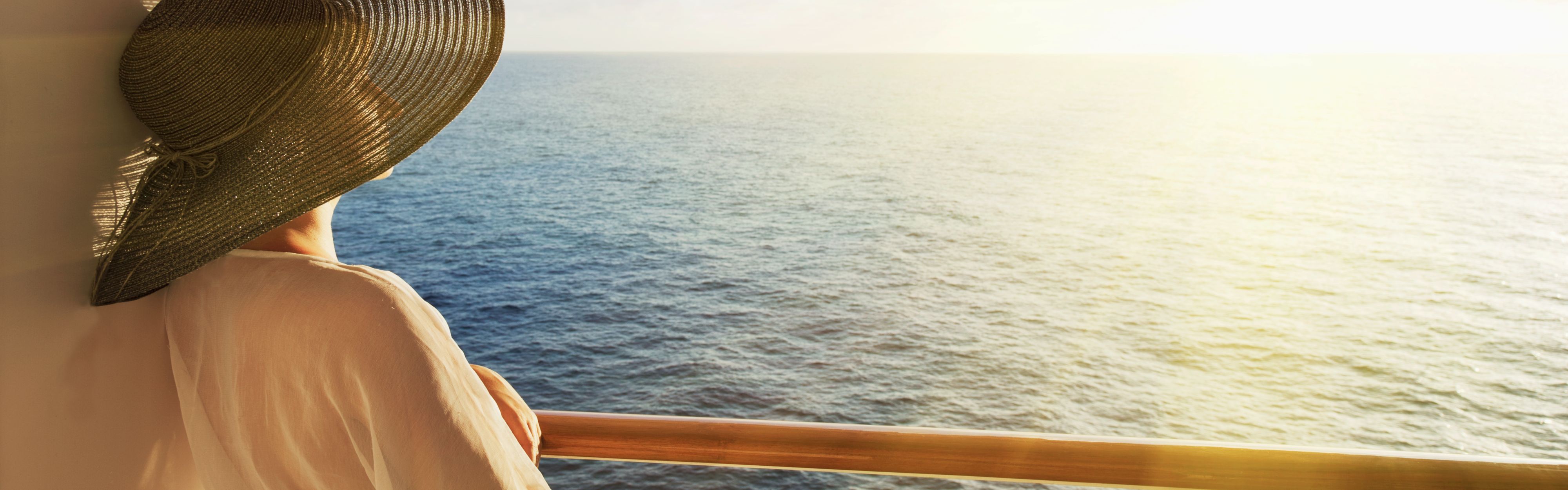 woman on cruise ship looking out at ocean