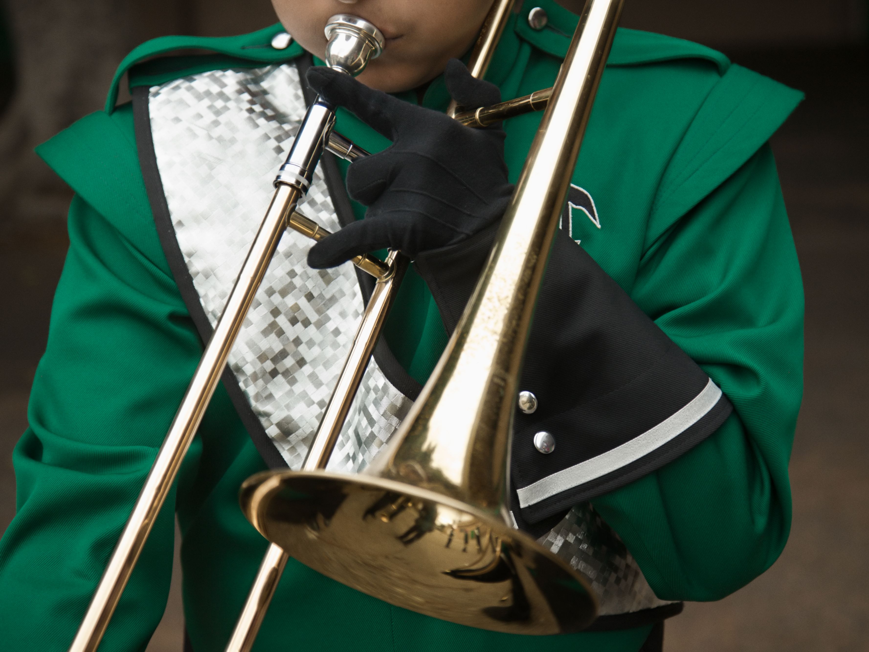 Marching band member with trombone