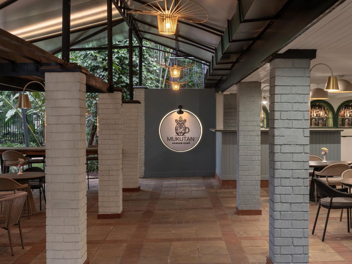 Modern restaurant entrance with covered terrace and seating