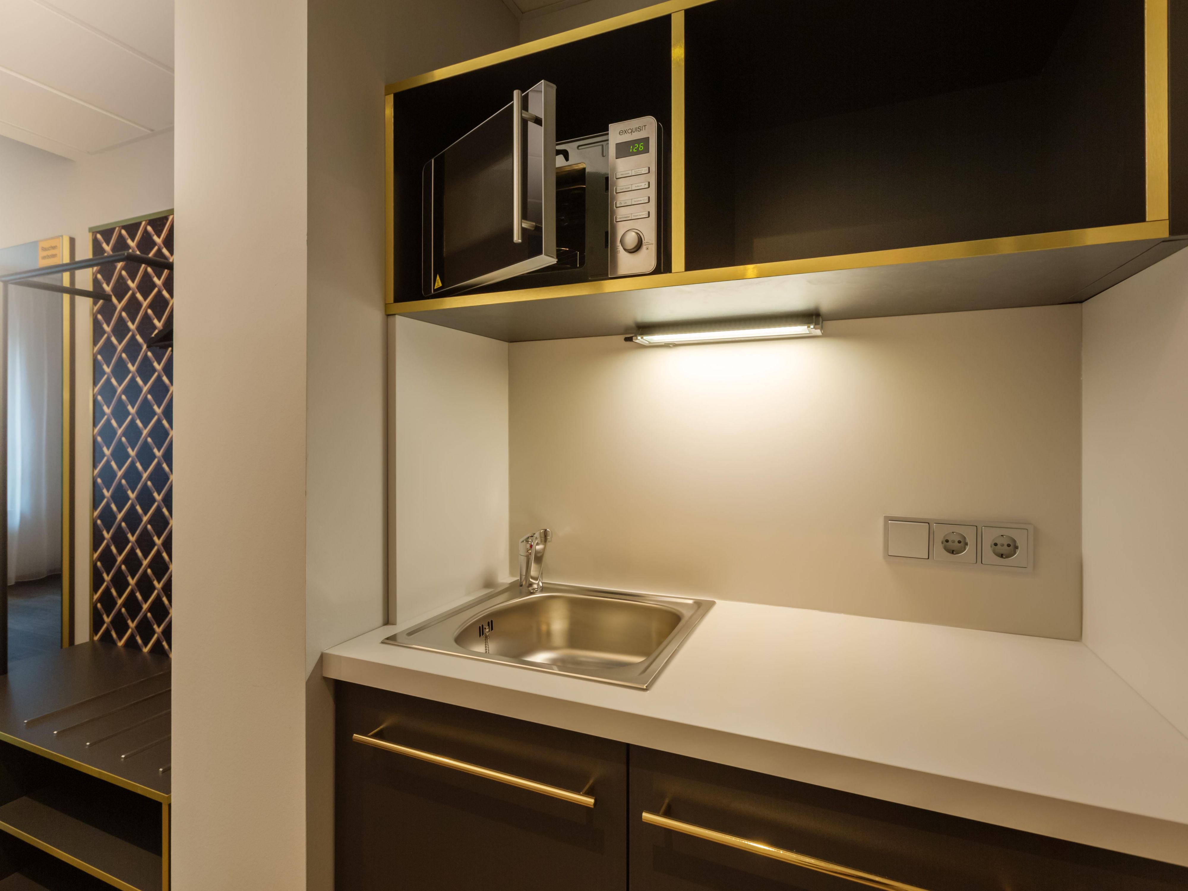 Experience the ultimate in convenience and comfort with our thoughtfully designed rooms, each featuring a convenient kitchenette equipped with a microwave and fridge. Whether you're preparing a quick snack or storing your favorite beverages, we've got you covered. Need a kettle or dishes? Just ask at reception, and we'll be happy to assist!