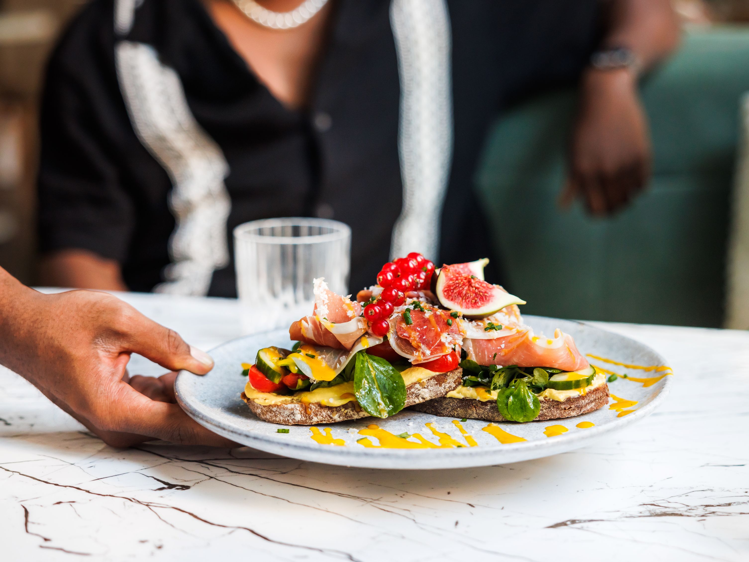 dish being placed in front of customer