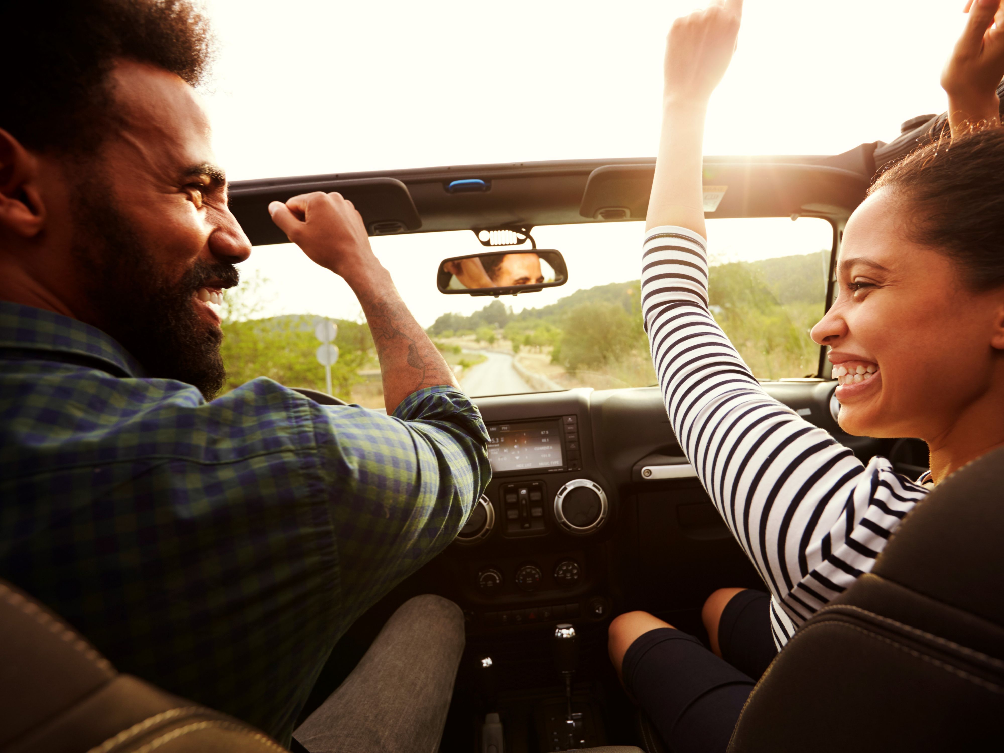 Couple driving in a car with the top down
