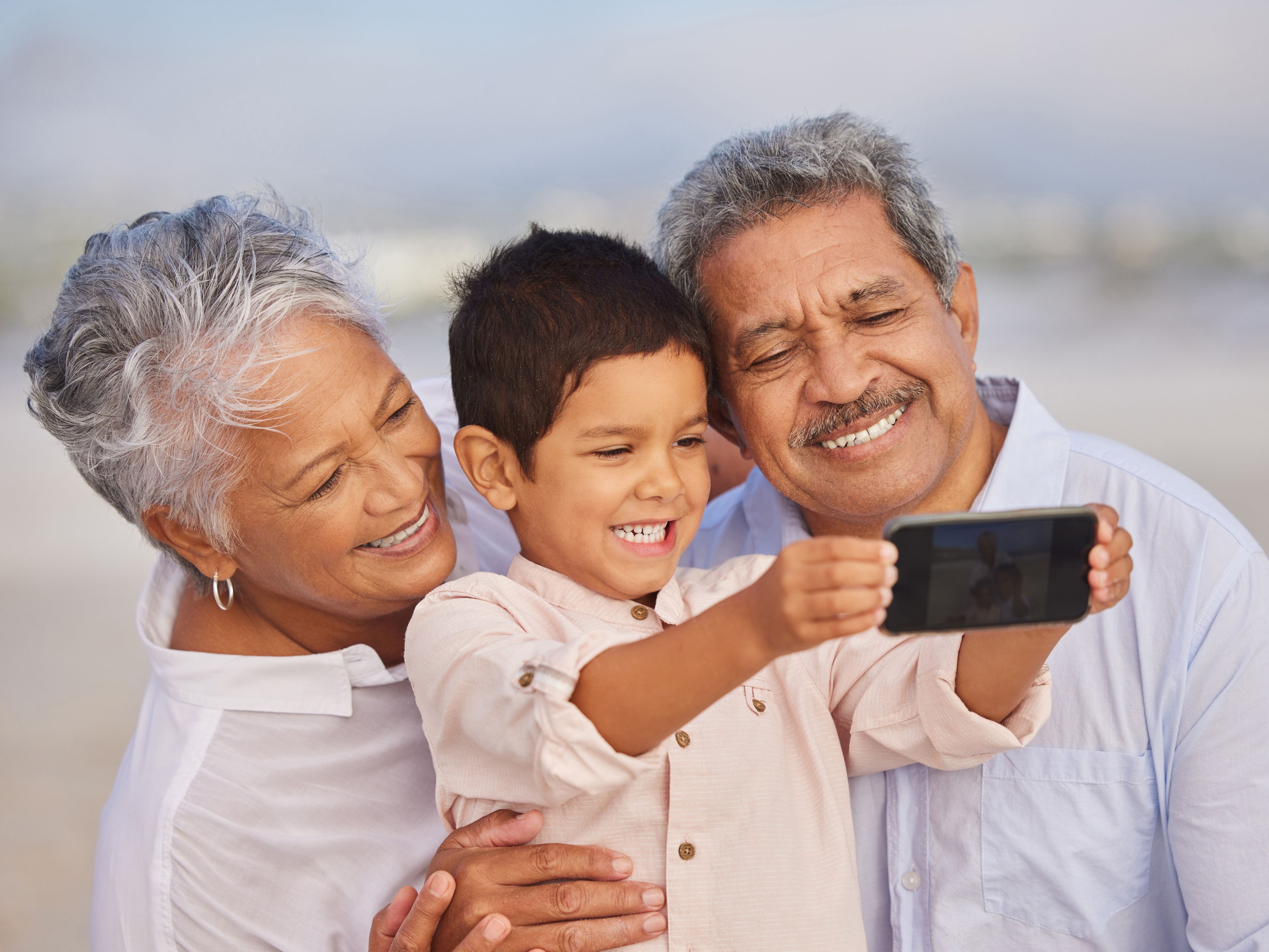Grandparents taking a selfie with their grandson