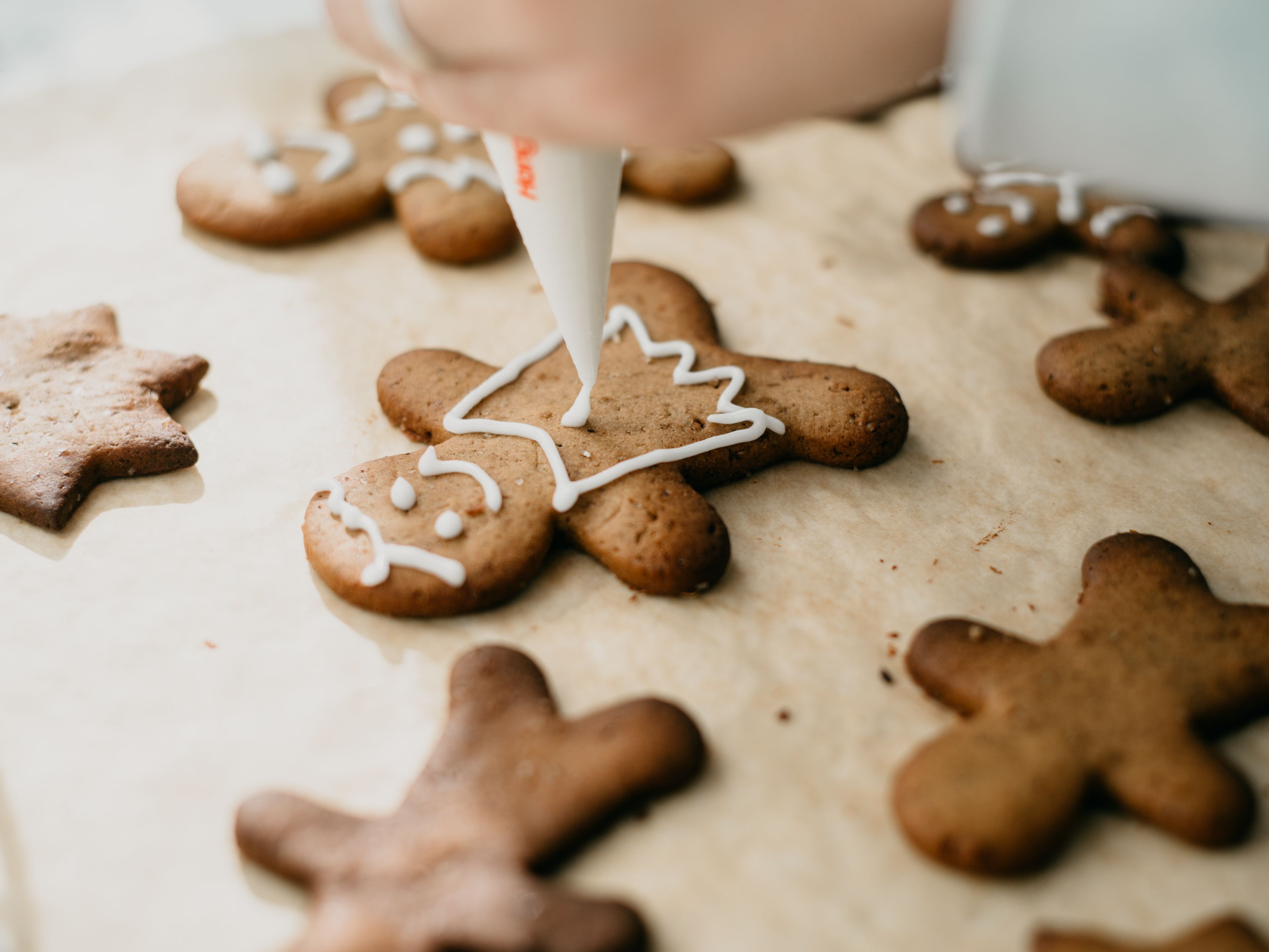 Chef decorating gingerbread cookies