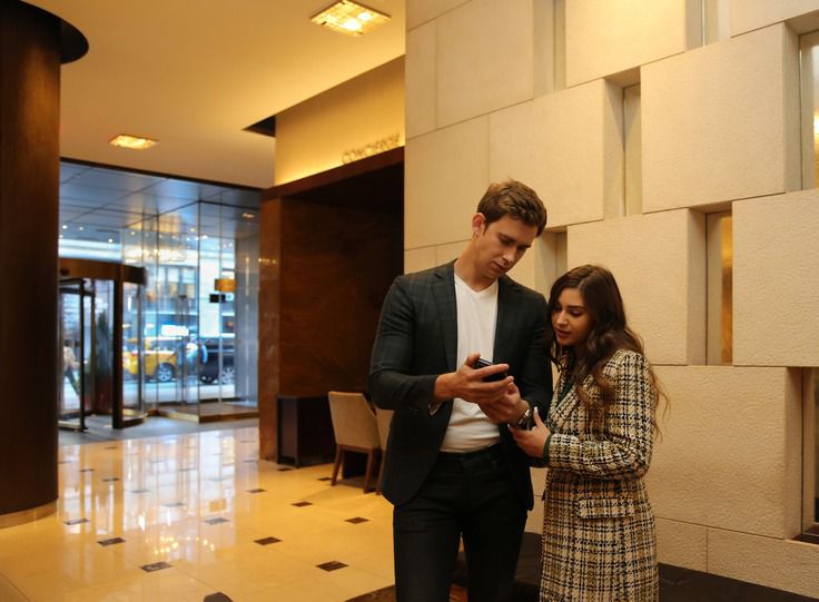 Woman and man looking at phone