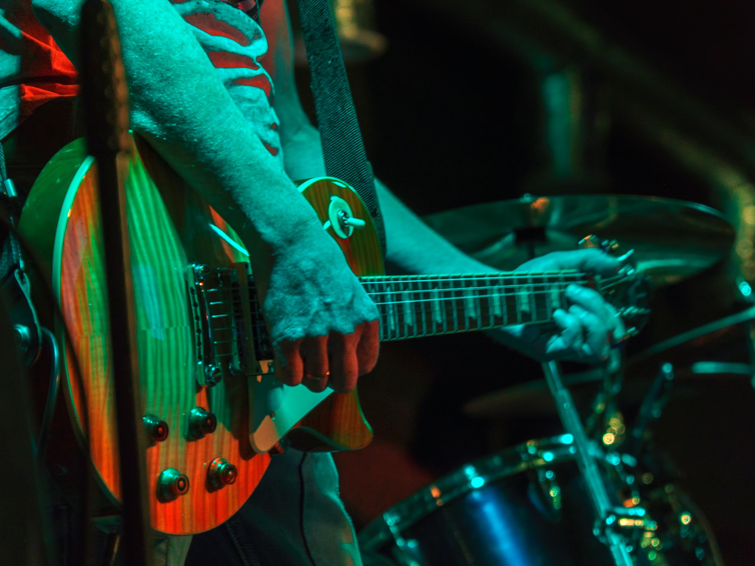 man playing electric guitar on stage