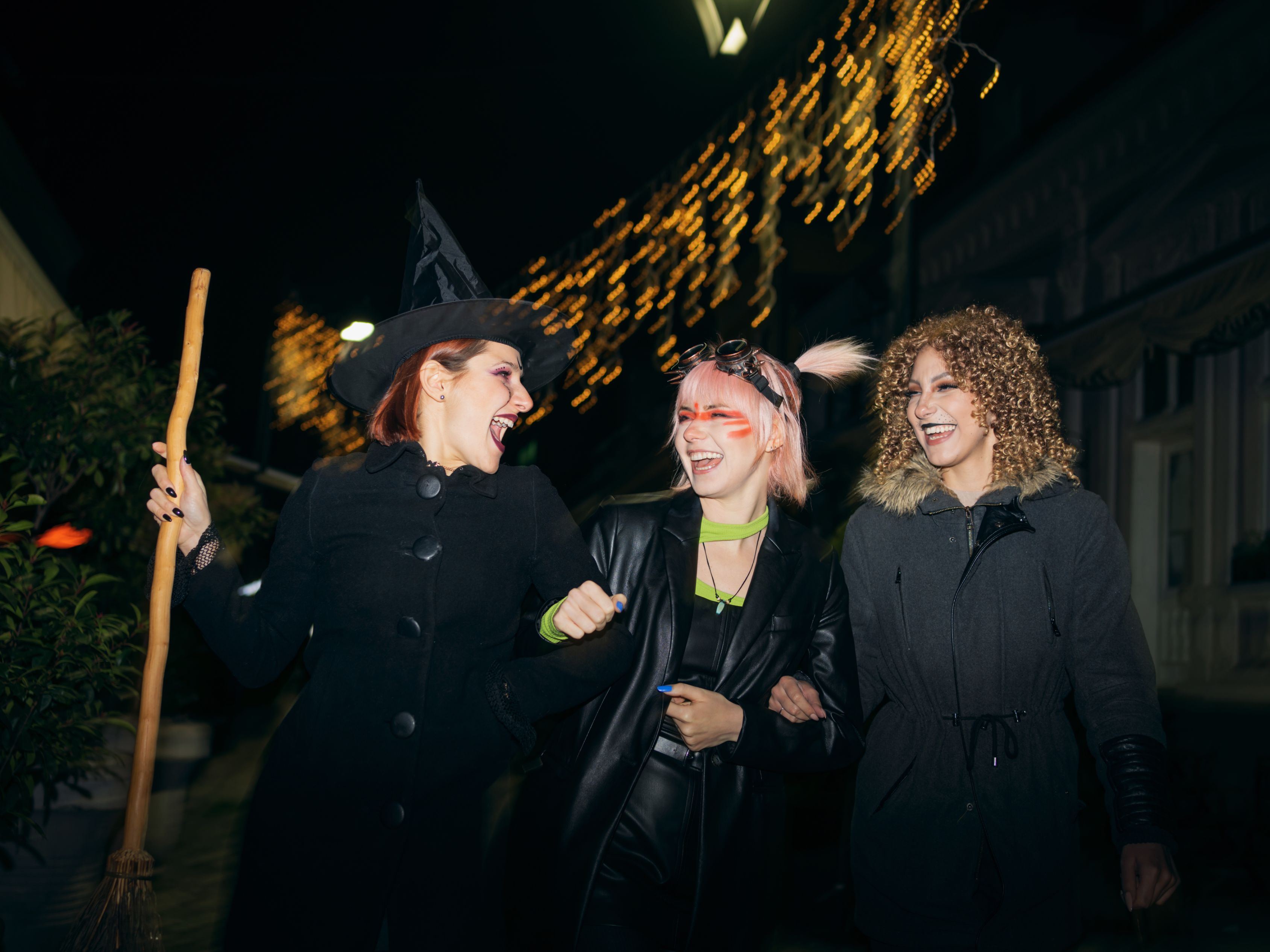Friends in Halloween costumes walking down the street