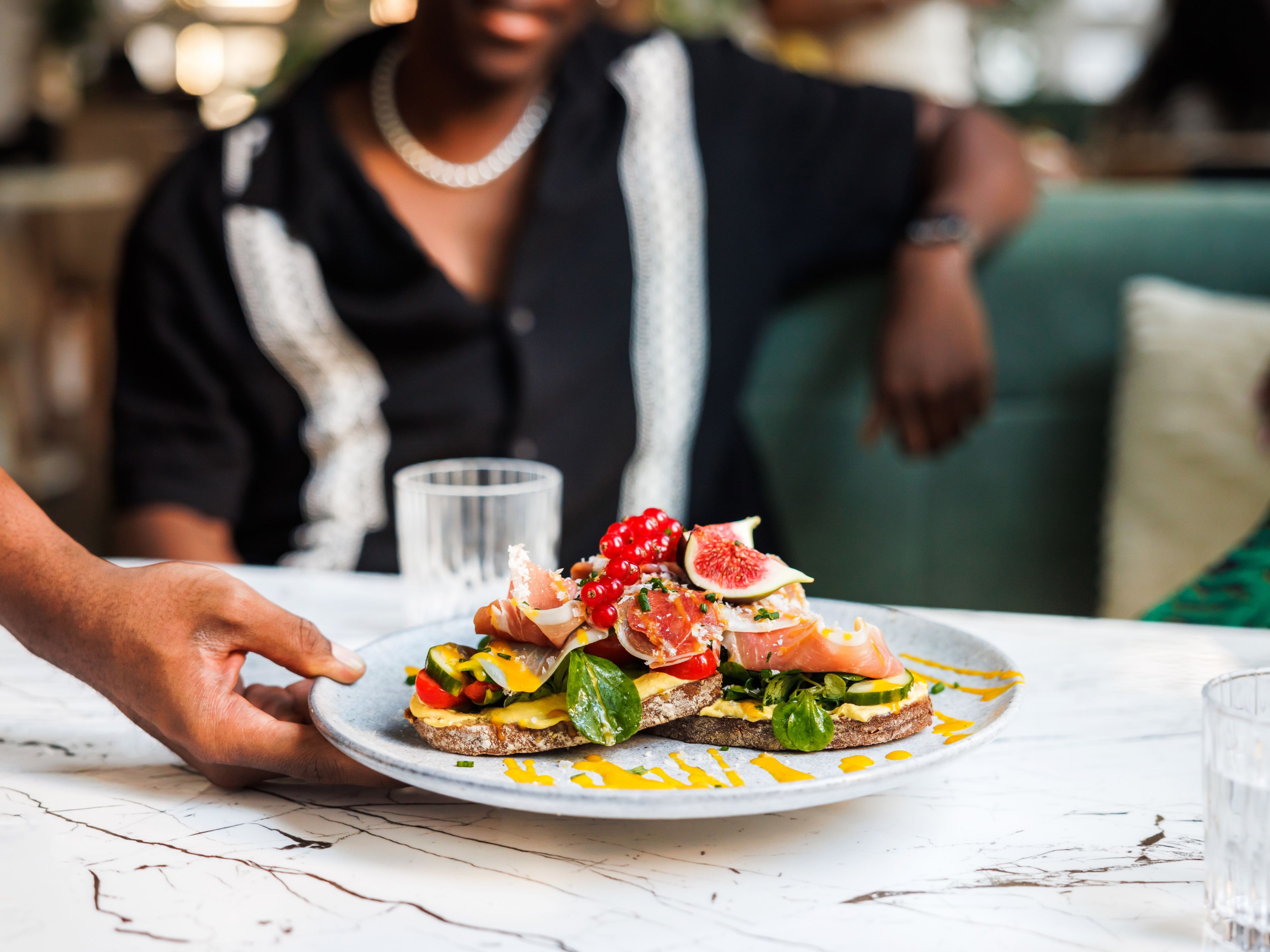 Gourmet open-faced sandwich being served